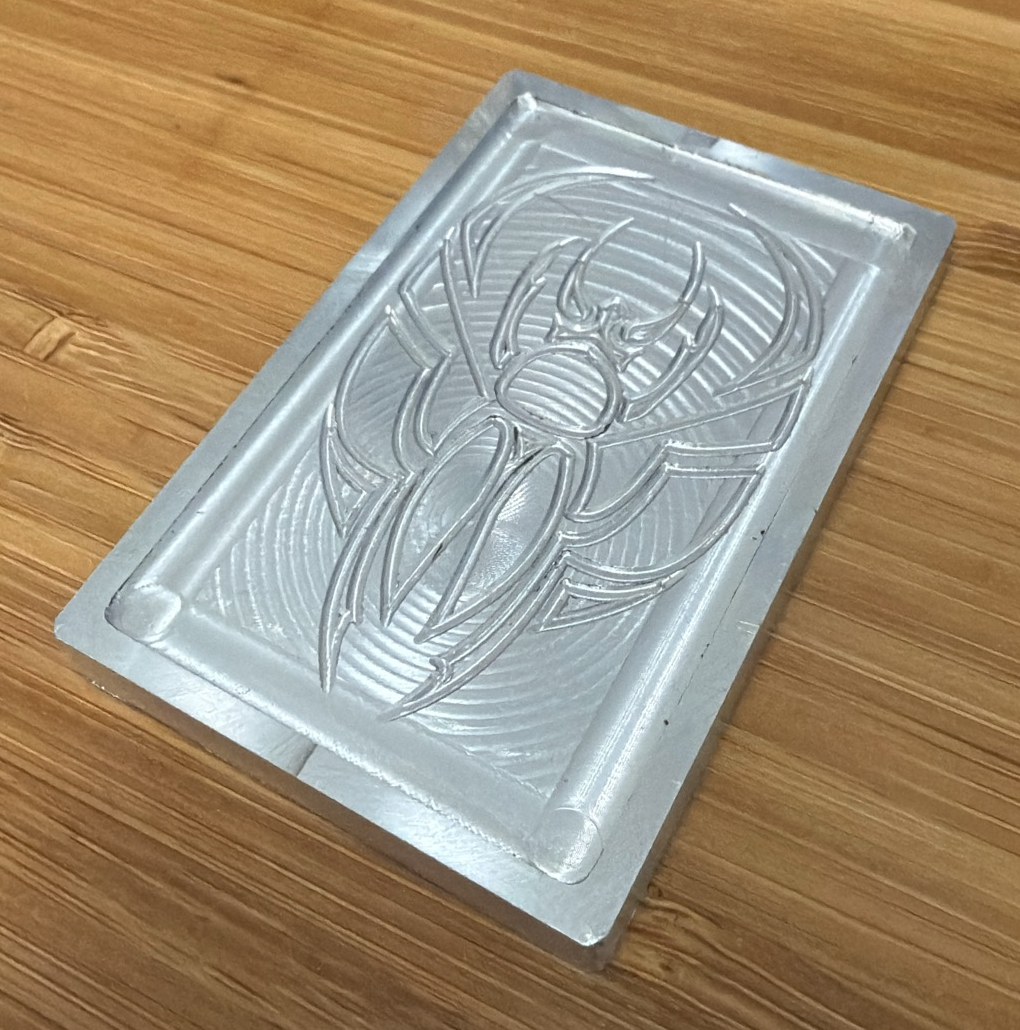 Ricks Machining in-house scarab design, angled view showing the machined surface.