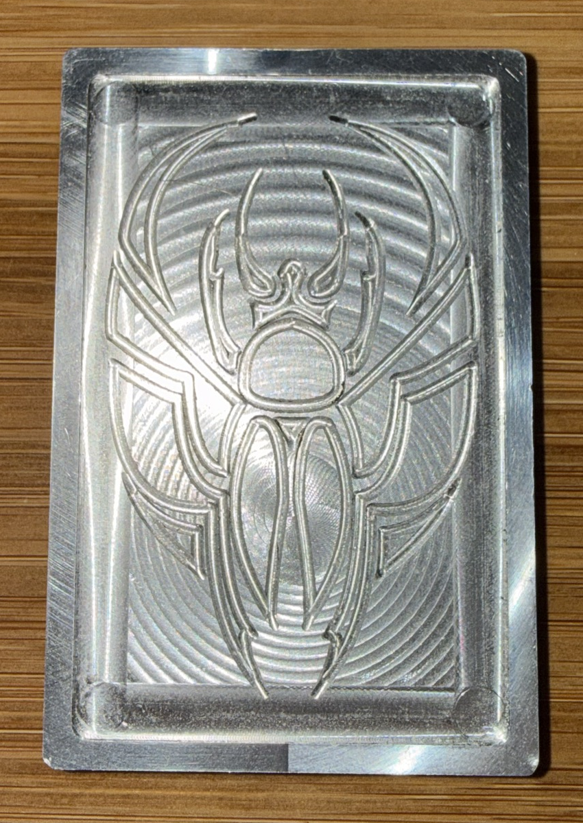 Ricks Machining in-house scarab design, straight-on view showing engraved details.