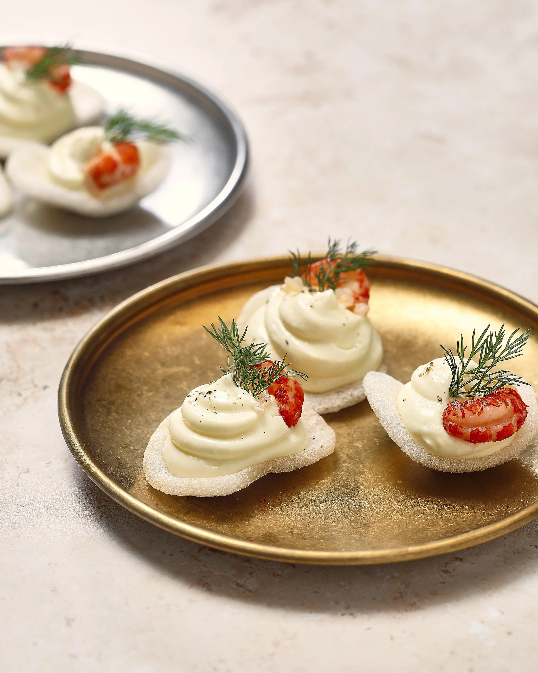 Sarah Ghijselinck food stylist; fine dining, Canapés with shrimp, dill, and cream cheese on a gold Bon Bistro plate.