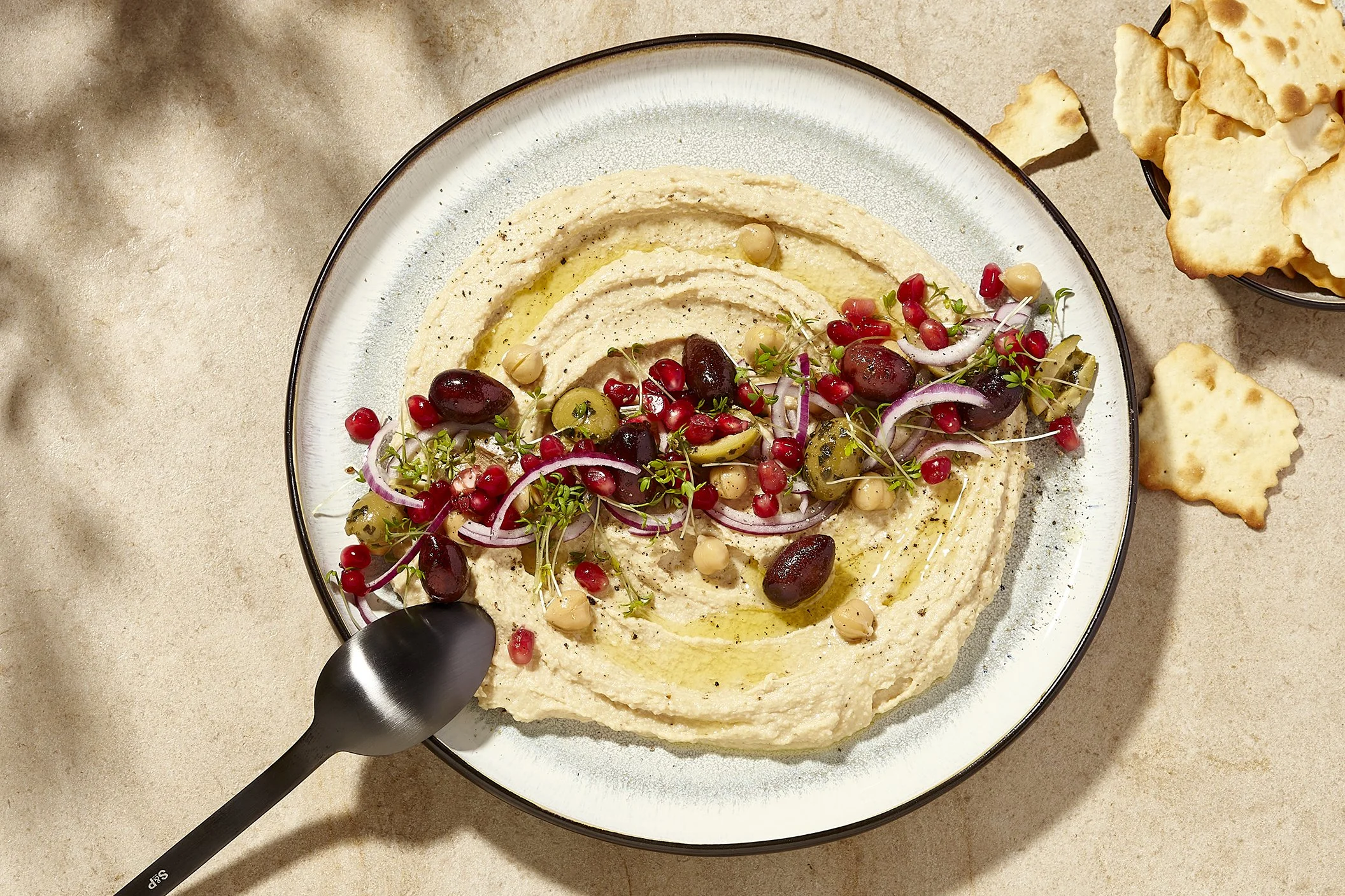 Sarah Ghijselinck, food and drink stylist, art direction, recipe development, Gent, fine dining, tableware photography.Plate of hummus with toppings for salt&pepper