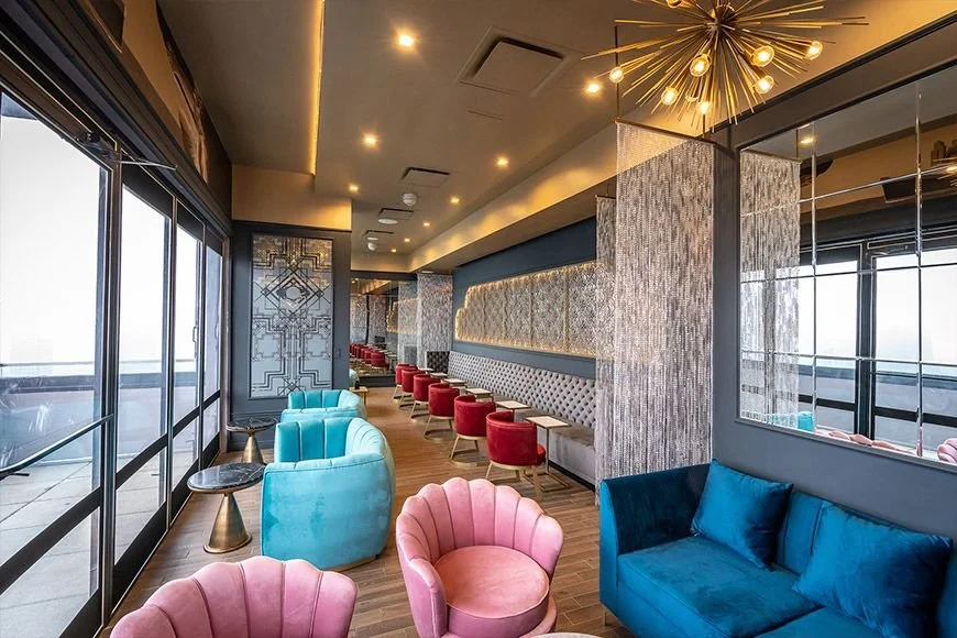 New York City cocktail bar interiro with bespoke seating in pink, blue and red leather