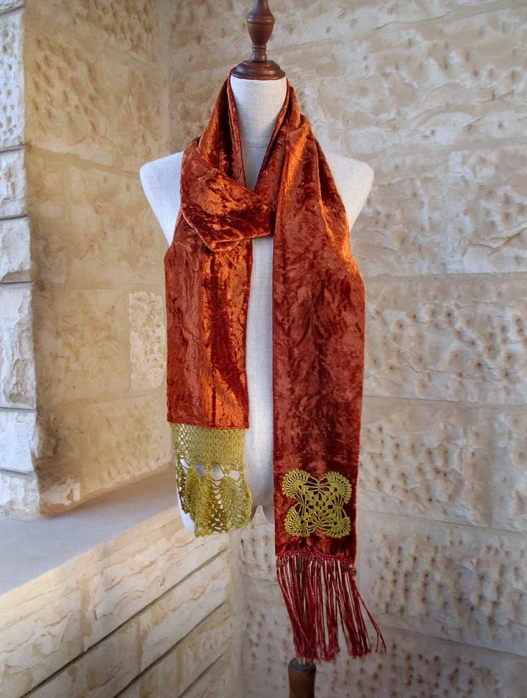 This vibrant vivacious orange velvet scarf will make the room pop with delight at the same time the crochet pieces add a feminine touch