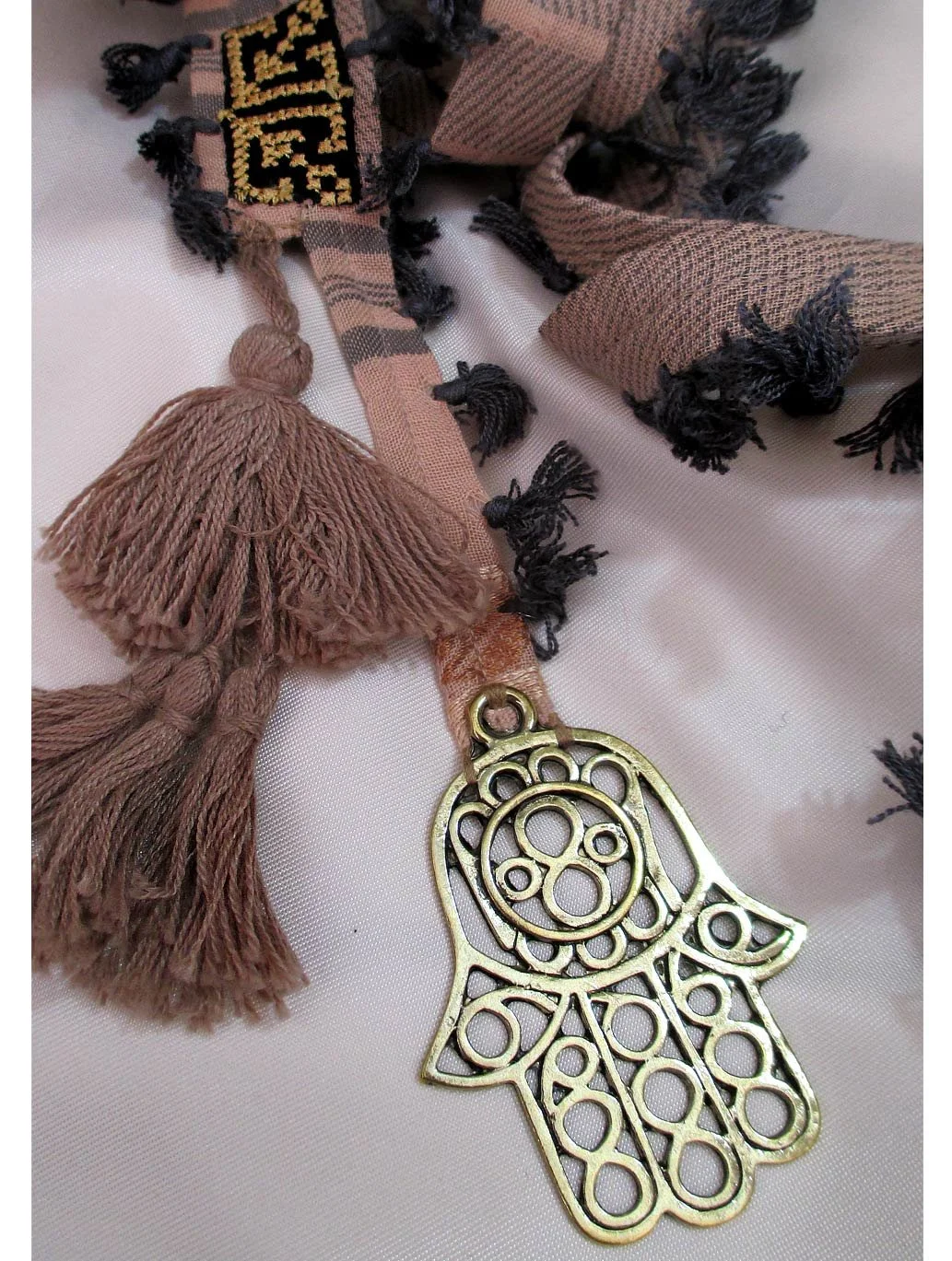 long necklace, tasseled Keffiyeh stripe adorned with the attention-grabbing Hand of Fatima metal big charm
