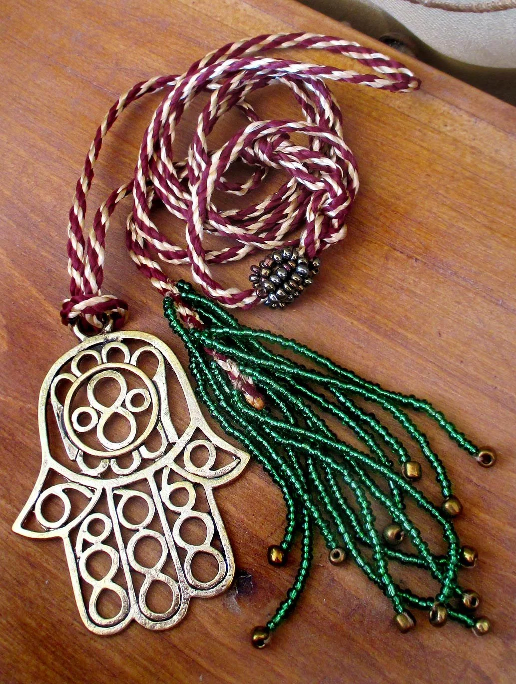 Unique long necklace, simple beaded stripe adorned with the the attention-grabbing Hand of Fatima charm