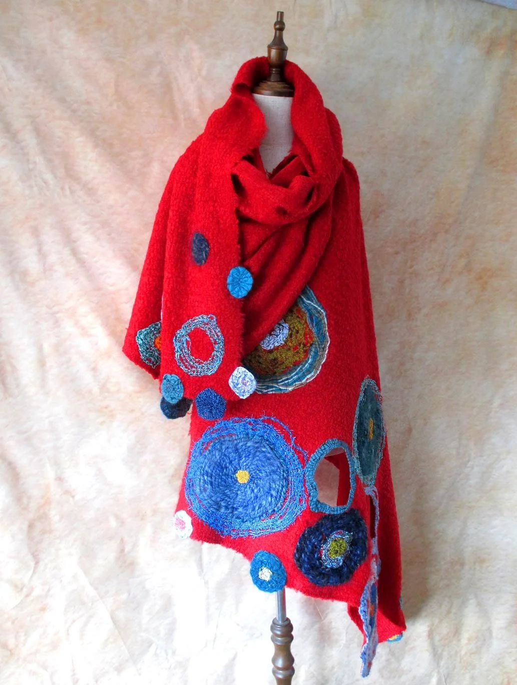 circles of a variety of yarns embroidered on 50% natural wool fabric makes this shawl saturated with warmth