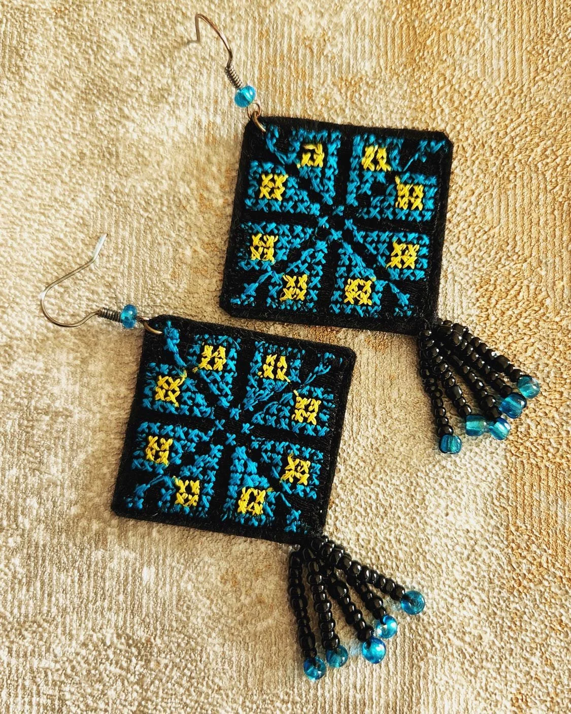 Inspired from the long heritage of Palestine, this earring is stitched in a pattern taken from the essence of the Palestinian embroidery that is used to embellish Palestinian women dresses over ages