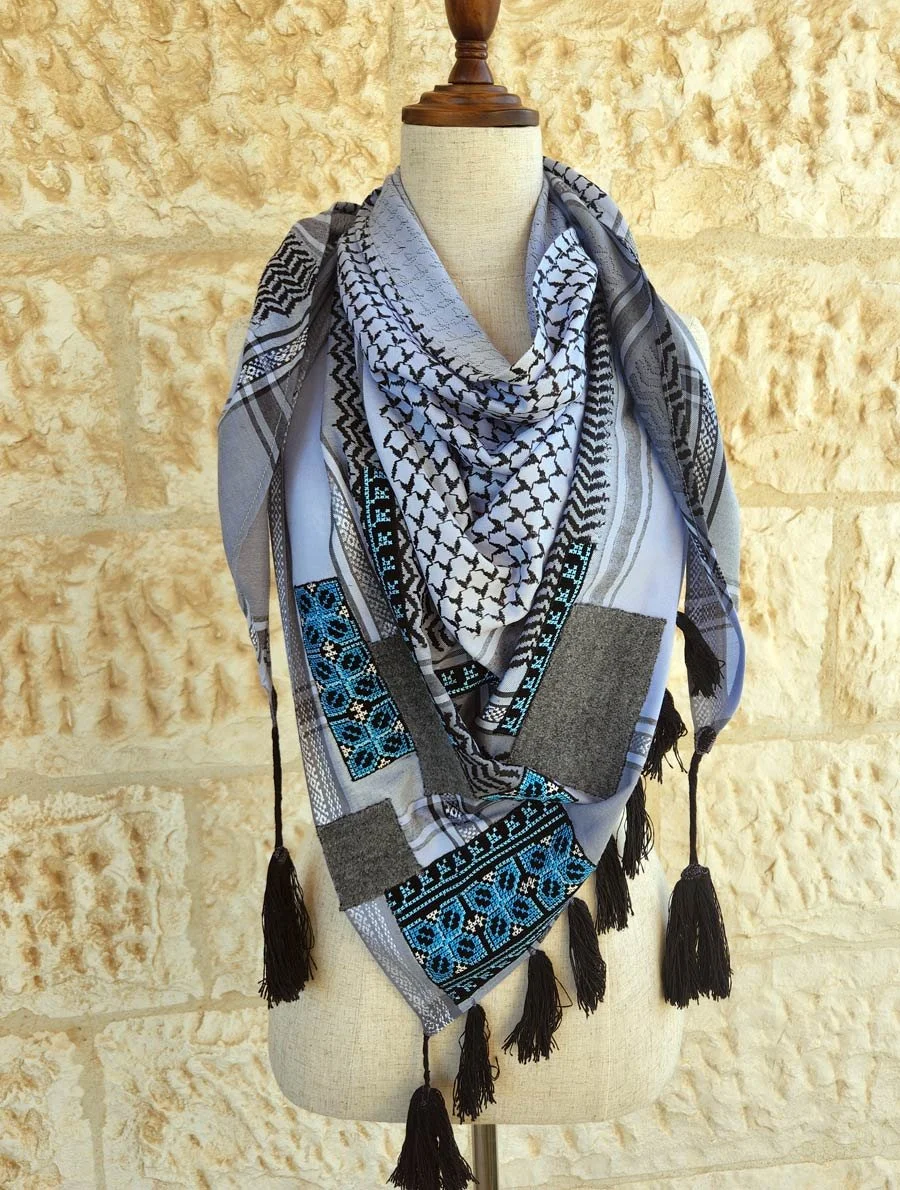 Wrap yourself in timeless style with this Keffiyeh Triangle Scarf, beautifully accented with Palestinian Embroidery and tweed patches made from 20% natural wool