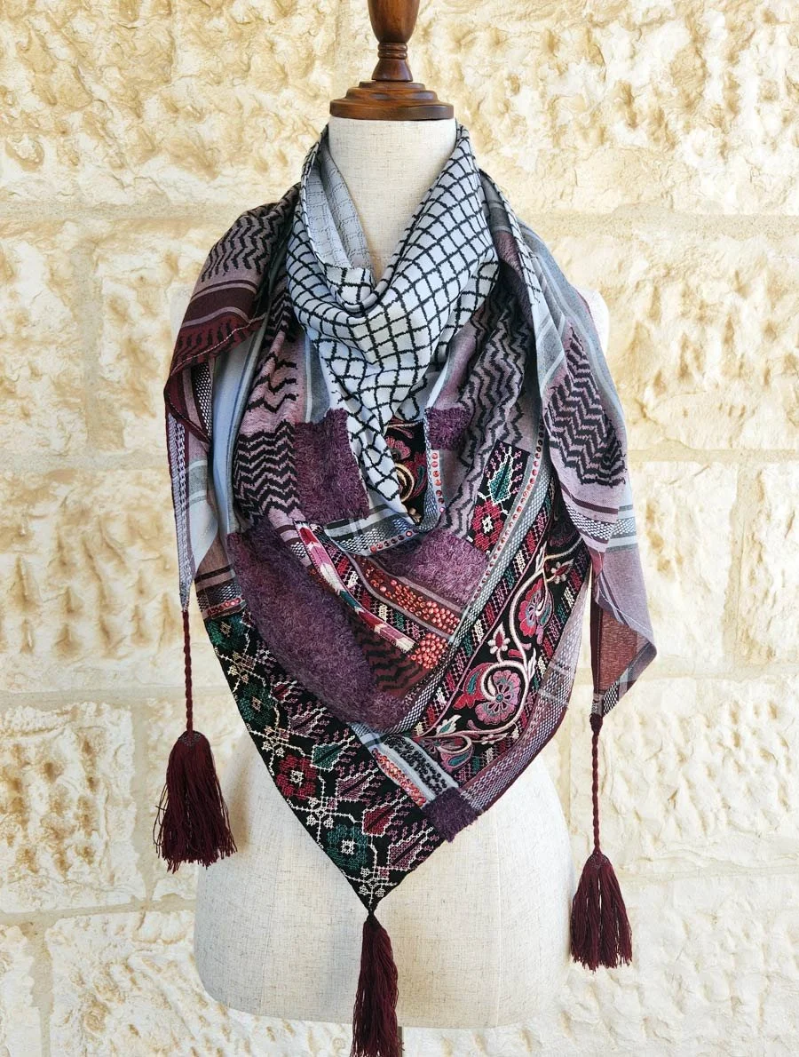 Wrap yourself in timeless style with this Keffiyeh Triangle Scarf, beautifully accented with Palestinian Embroidery and tweed patches made from 20% natural wool