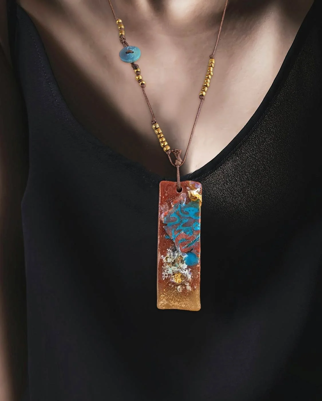 Discover the Sealed Secrets ... Resin Pendant Necklace, a one-of-a-kind design with floating elements, beaded details, and a unique front clasp. A mysterious piece of wearable art.