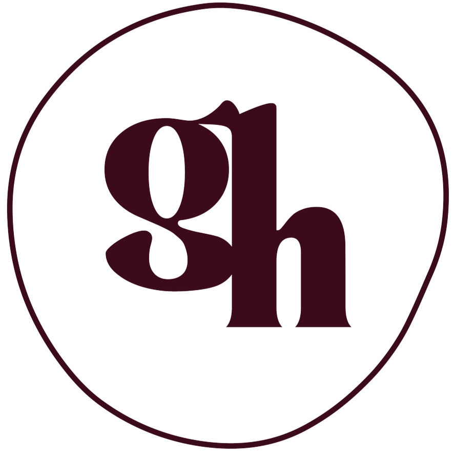 A black circular logo with the lowercase letters 'g' and 'h' in a stylized font, outlined by a thin black border.