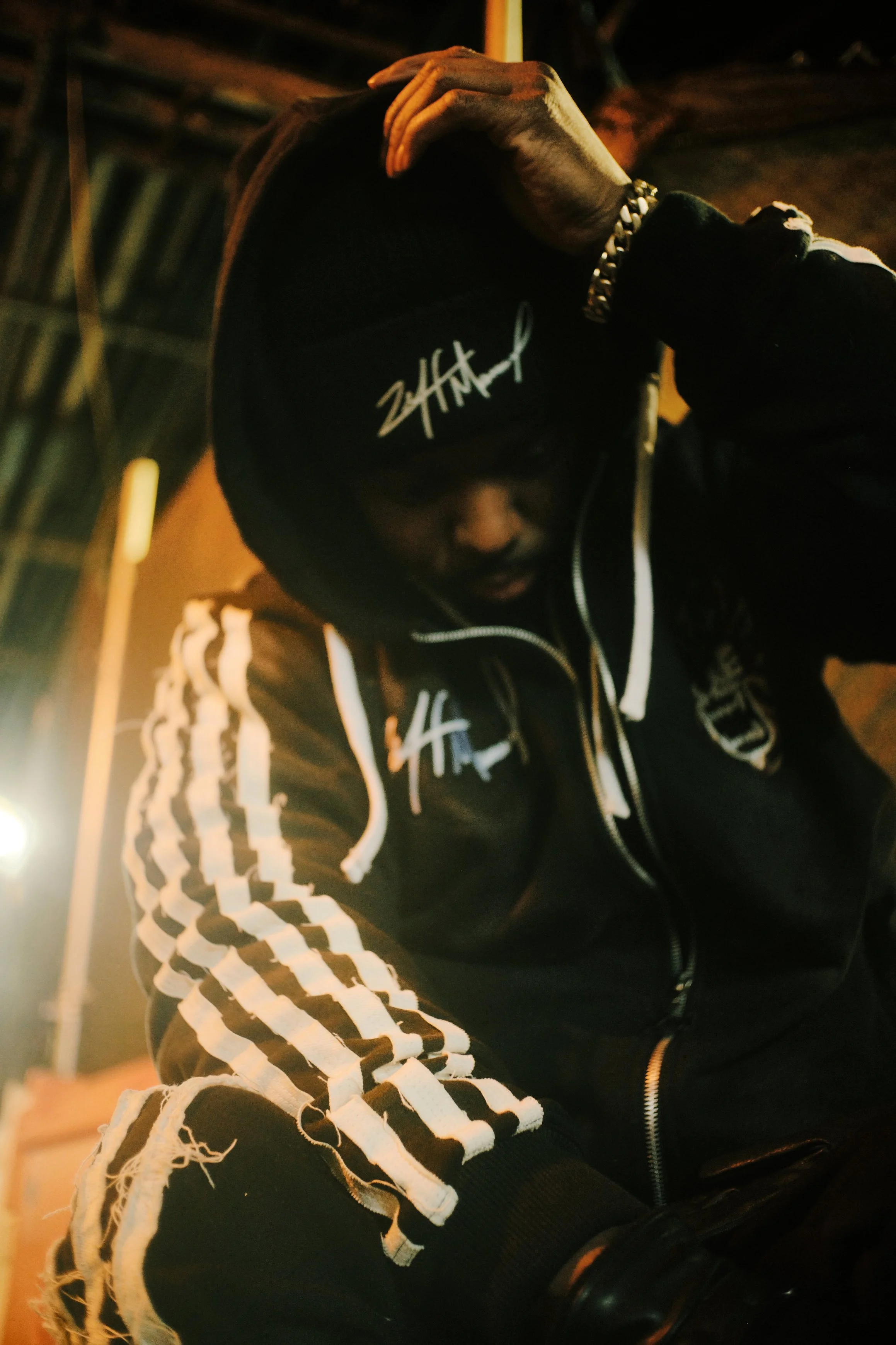 A man in a dark hooded sweater at a NYC subway station. JSnaps Photography New York City Fashion lifestyle photography 