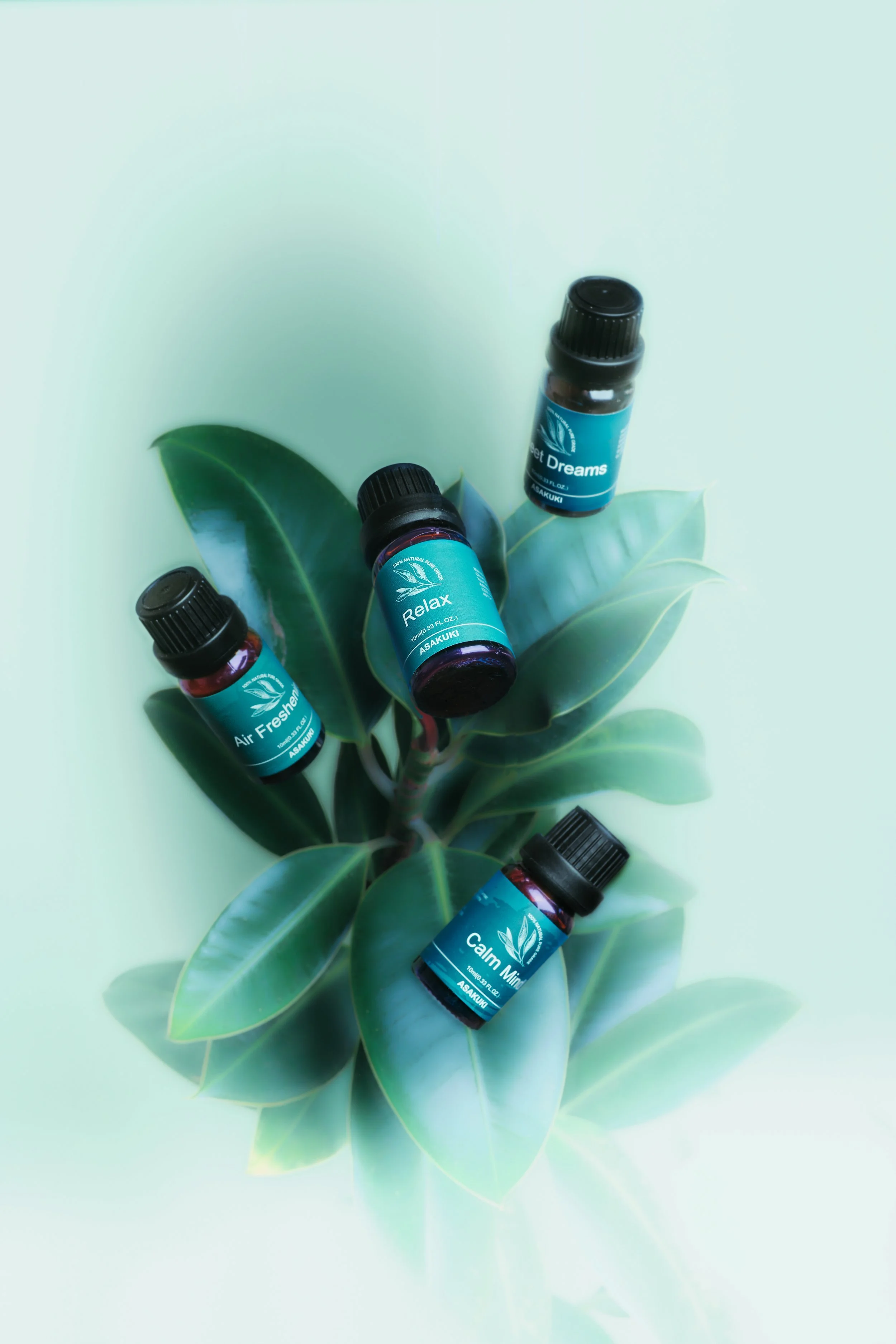 Small bottles of essential oils, one labeled 'Air Freshening' and the other 'Calm Mind,' placed against a green leafy background. JSnaps Product Photography
E-commerce Commercial Photography New York City 