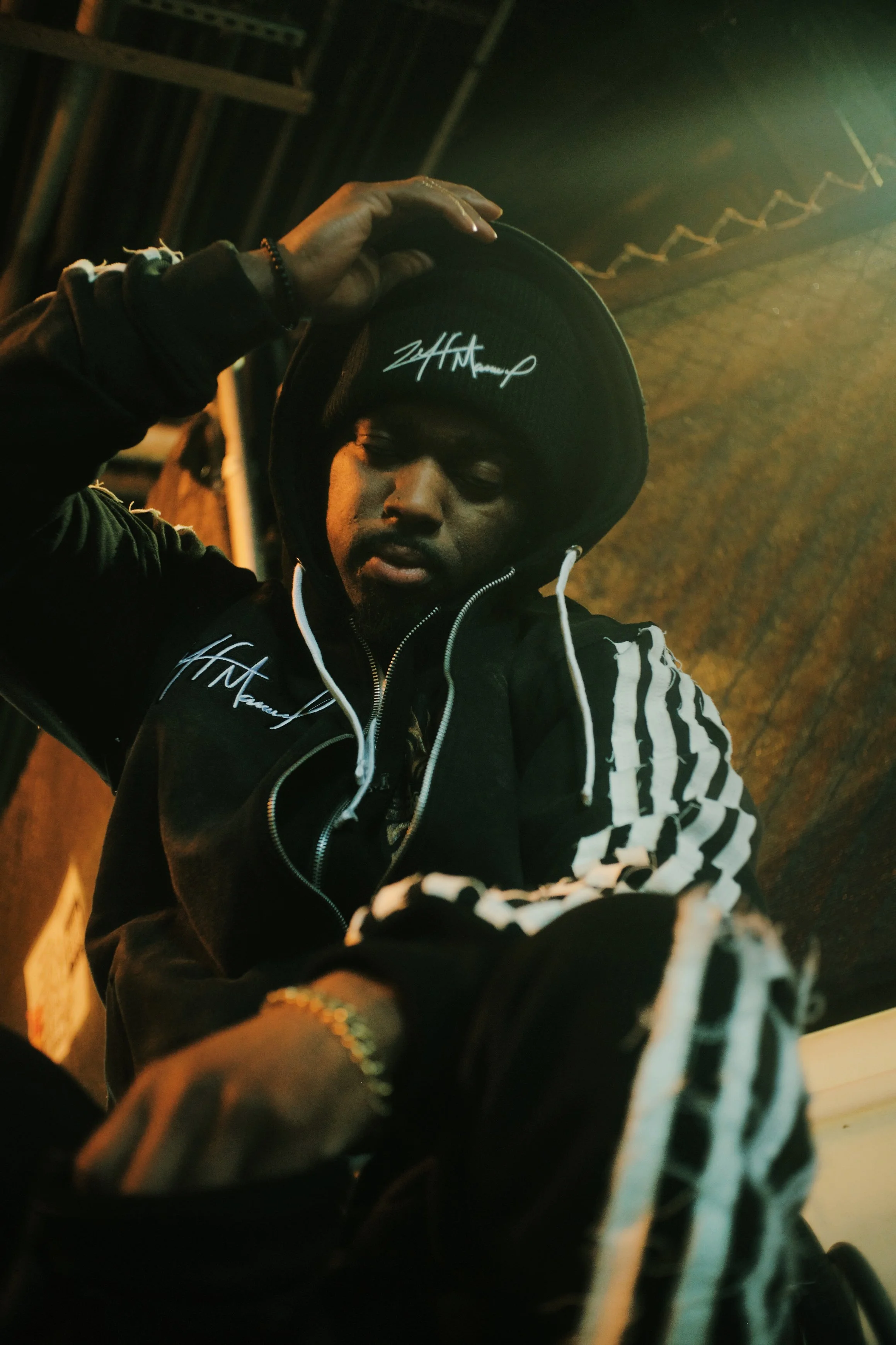 A man in a dark hooded sweater at a NYC subway station. JSnaps Photography New York City Fashion lifestyle photography 