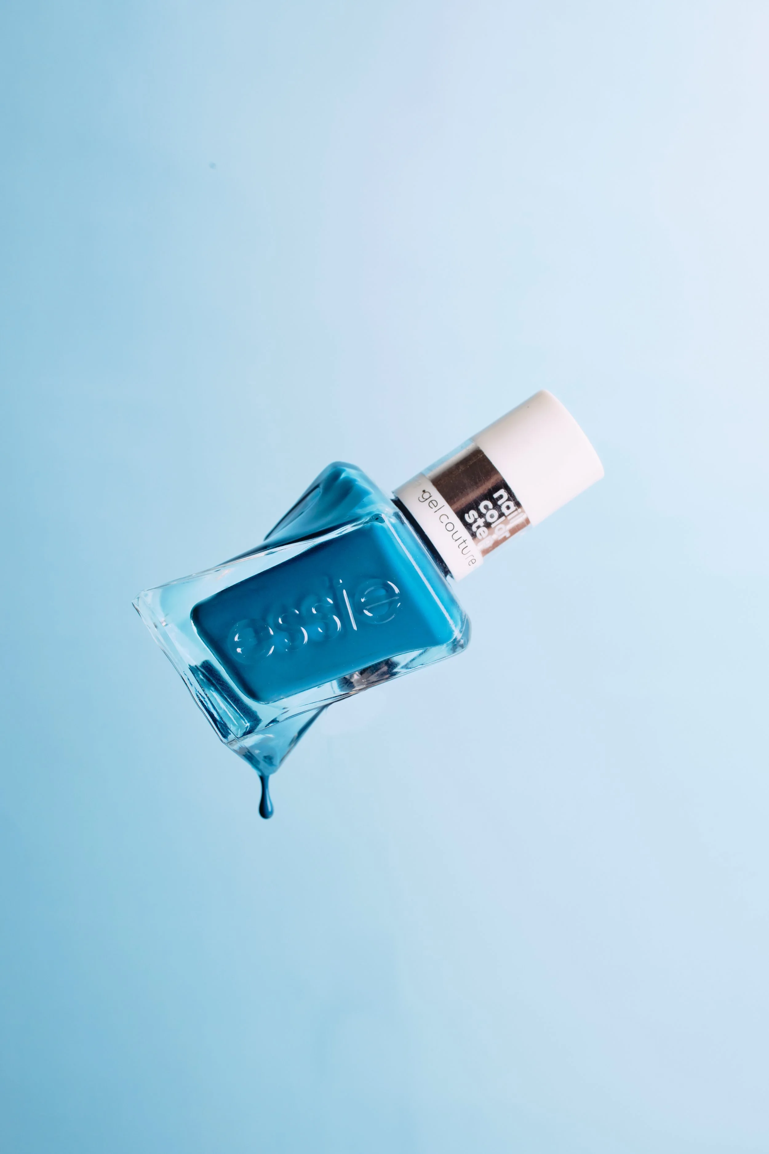 Blue Nail polish in a bottle dripping. JSnaps Product Photography  E-commerce Commercial Photography New York City 