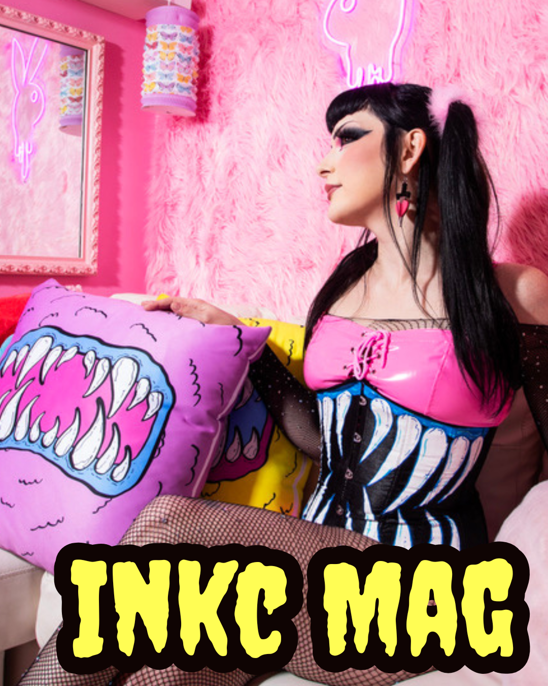 Girl sitting in pink room in Monster Corset. Monster Pillow Beside her. INKC MAG in text.