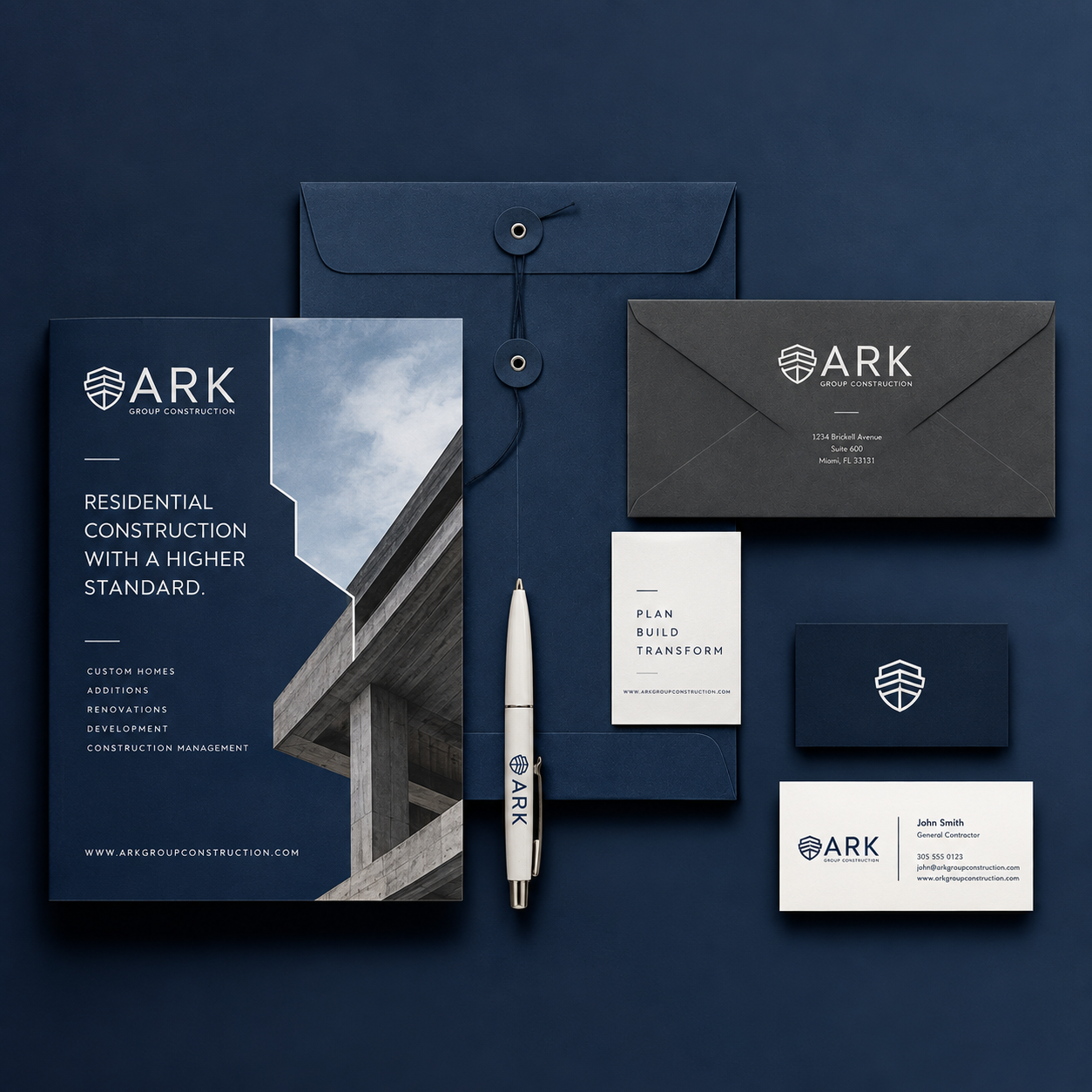 Branding and marketing materials for ARK Group Construction, featuring a brochure, business cards, envelope, and pen, all in blue, black, and white with construction-themed design elements.