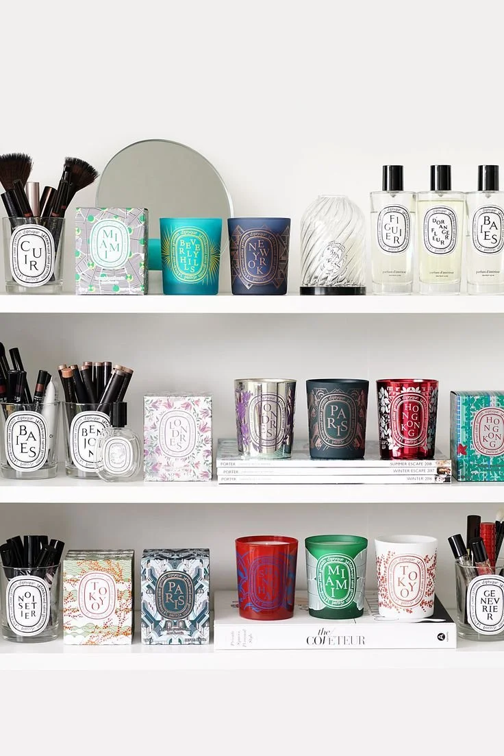 Image of Diptyque candles on a white shelf