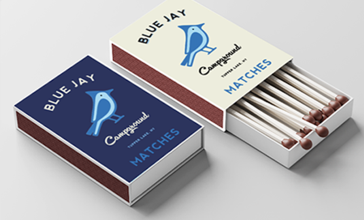 branding design example for small businesses showing Blue Jay Campground visual identity across matchboxes