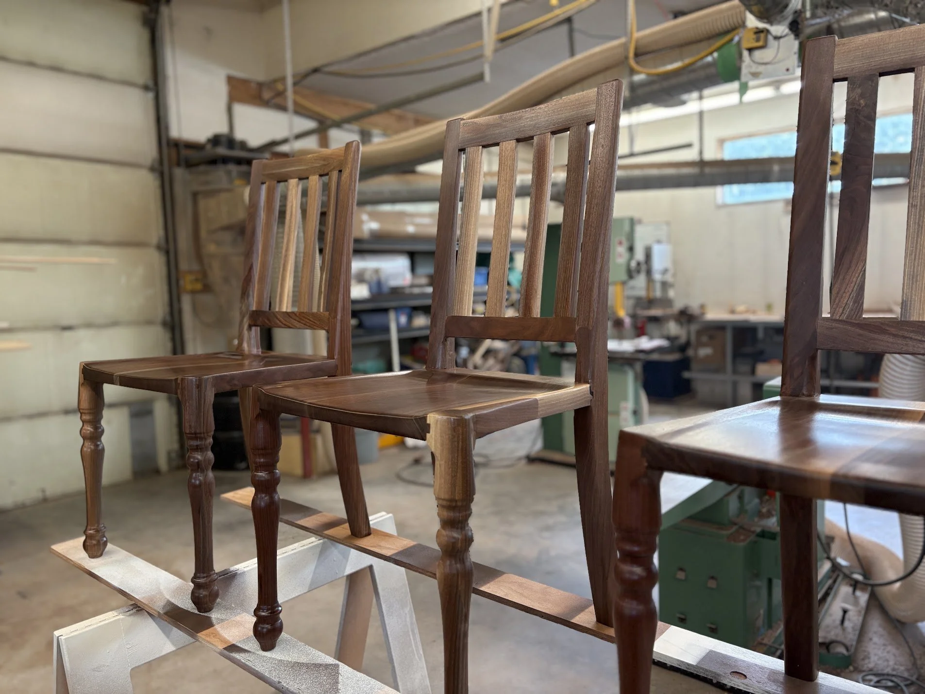 Artesão Traditional dining chairs in walnut with turned legs in the workshop