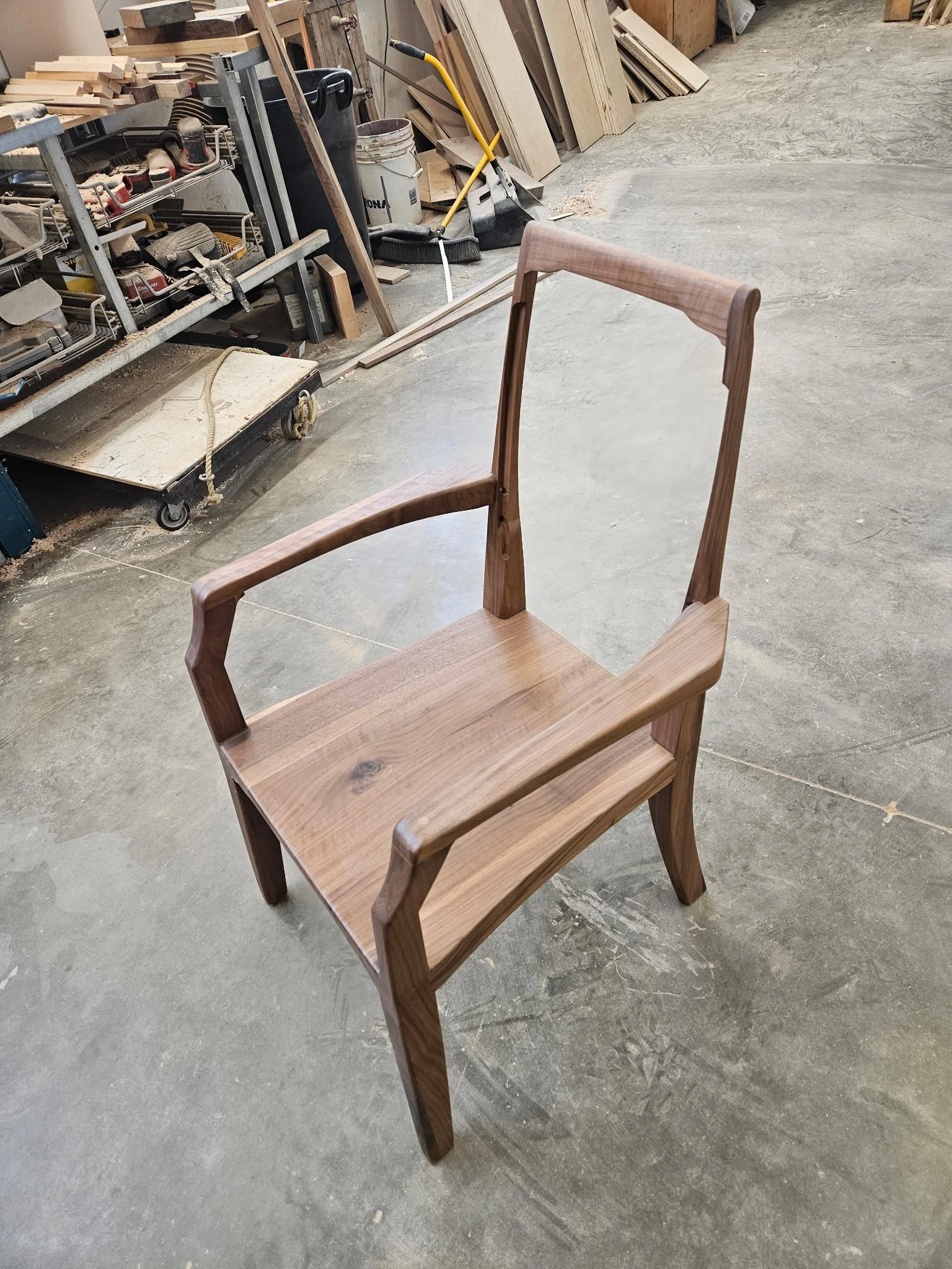 Artesão Legacy walnut dining armchair frame in the workshop