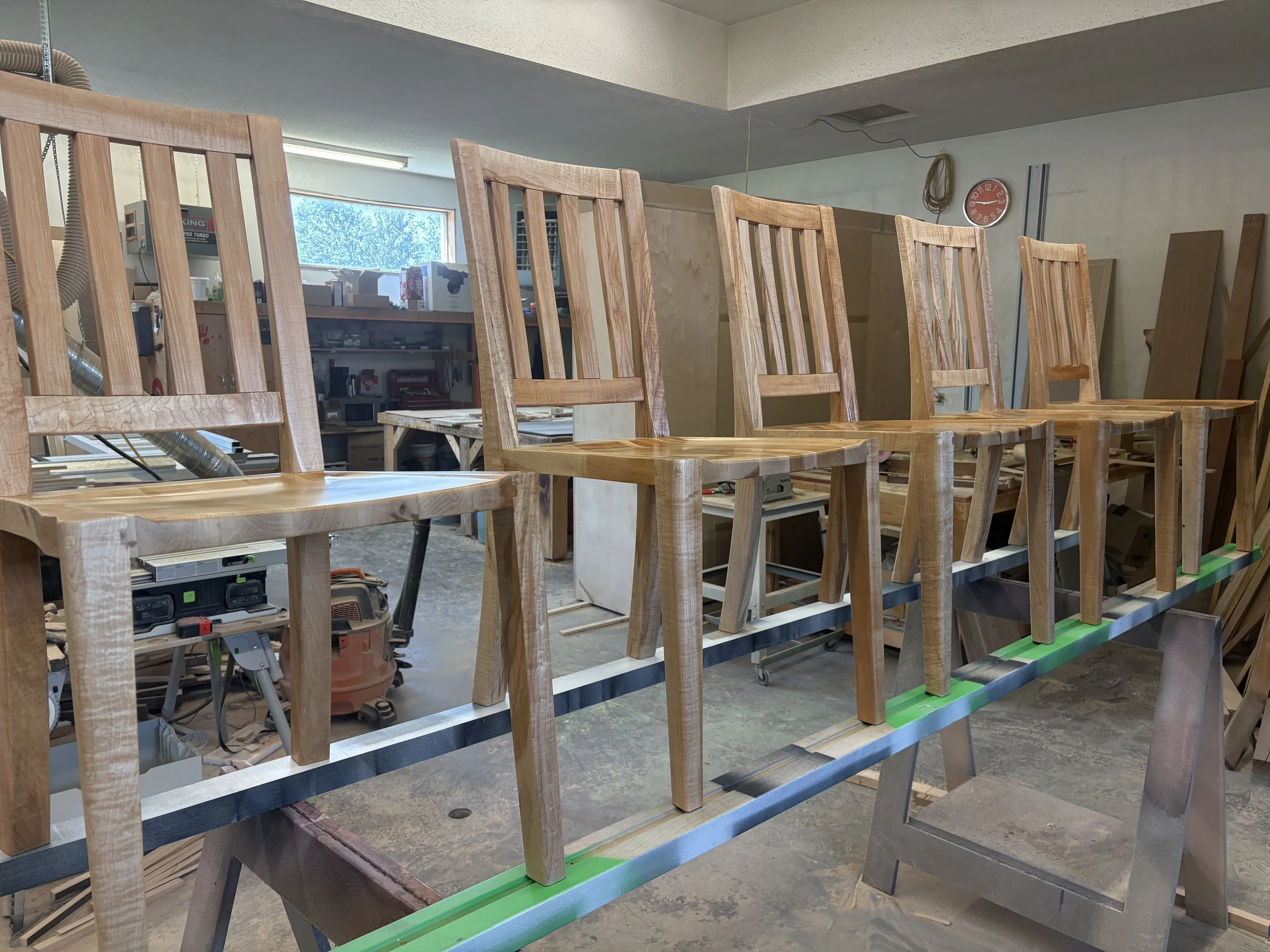 Artesão Traditional dining chair in curly maple with straight legs in the workshop