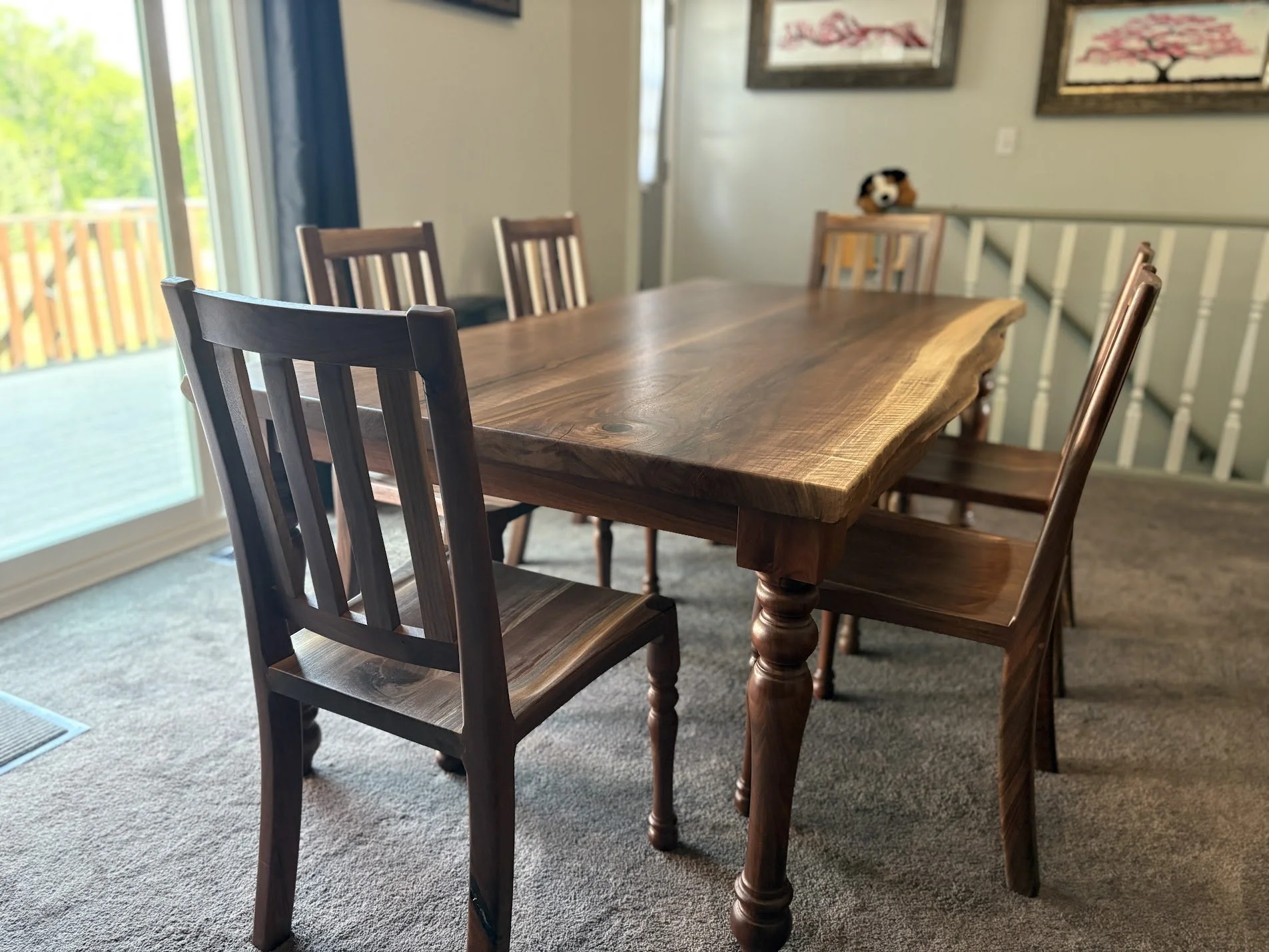 Artesão Traditional dining chair in walnut at a live-edge walnut dining table