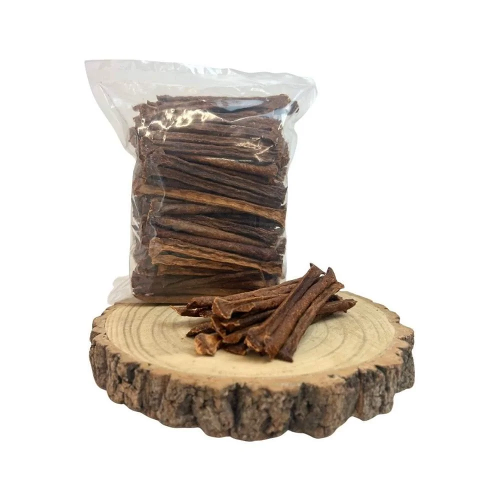 A clear plastic bag packed with Paddock Farm kangaroo muscle meat sticks next to a small pile on a rustic wooden slice.