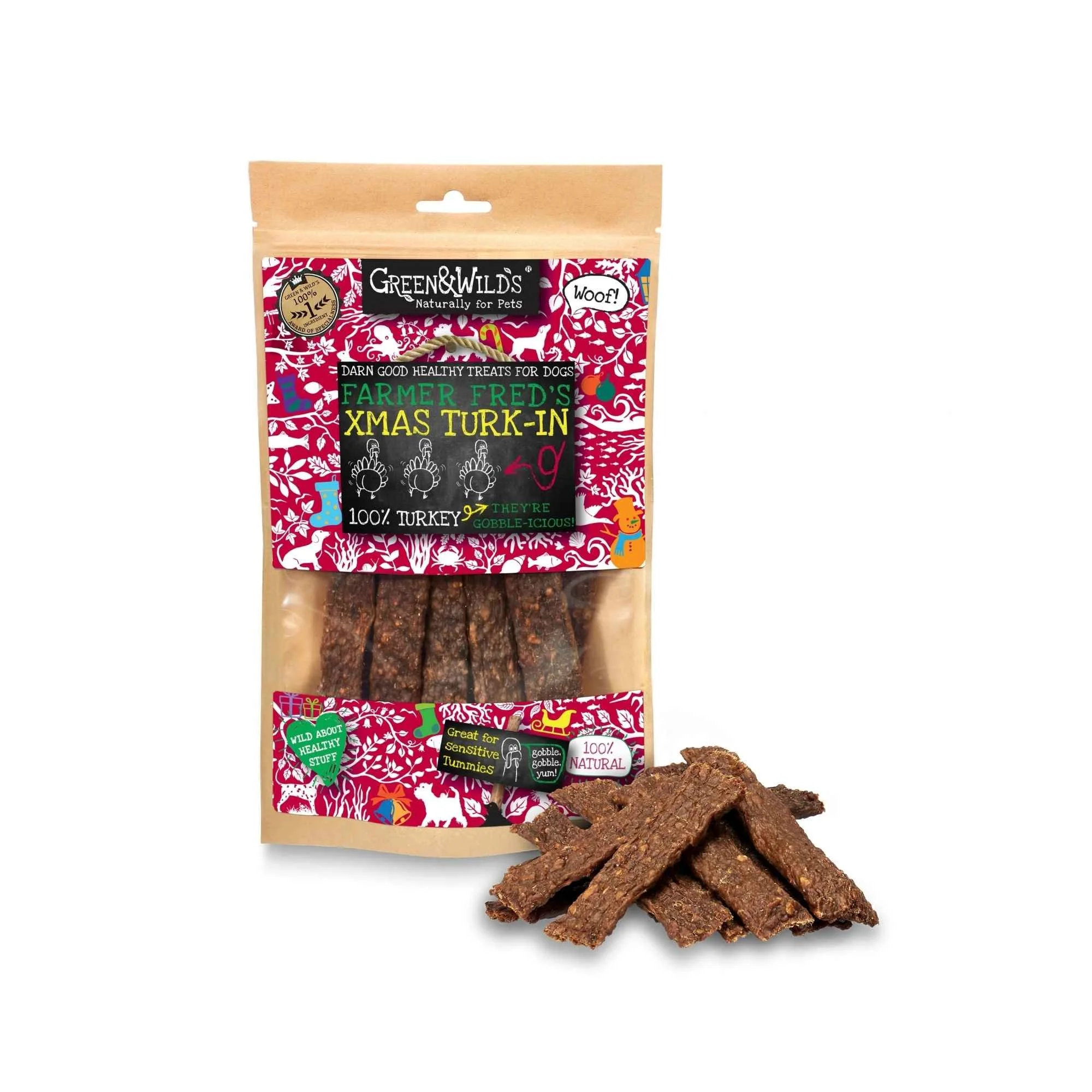 Green & Wild's Xmas Turk-In 100% turkey treats pouch standing beside a pile of flat, dried turkey strip treats on a plain white background.