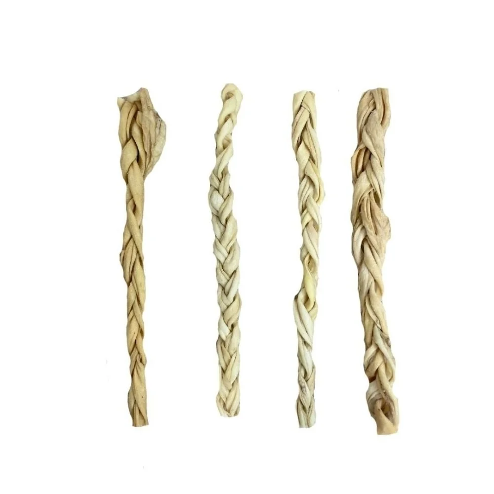 Four isolated Paddock Farm braided lamb skin dog treats against a clean white backdrop.