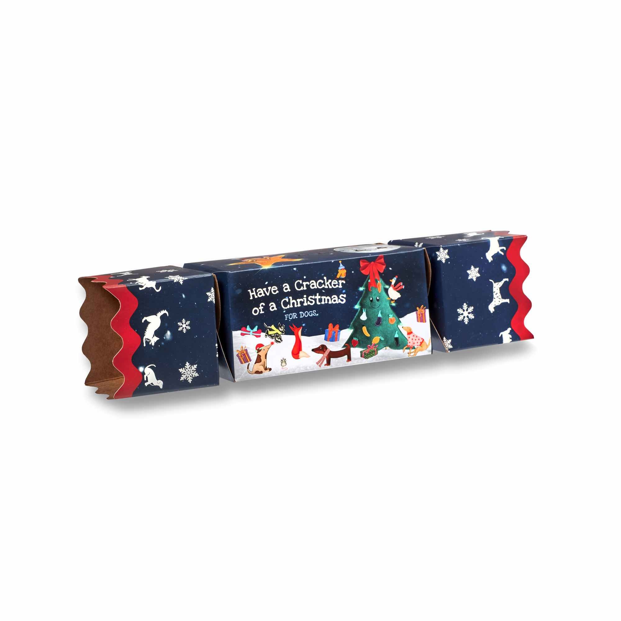 A closed Green & Wild's Dog Christmas Cracker featuring a festive winter illustration of forest animals.