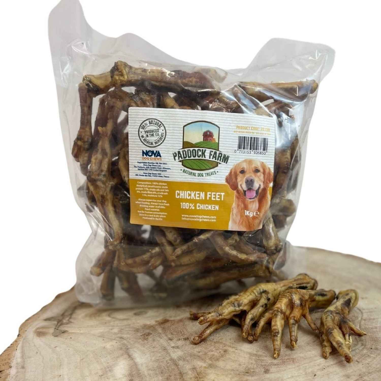 Paddock Farm clear bag of natural dried chicken feet dog treats resting on a rustic wood slice next to loose chicken feet chews