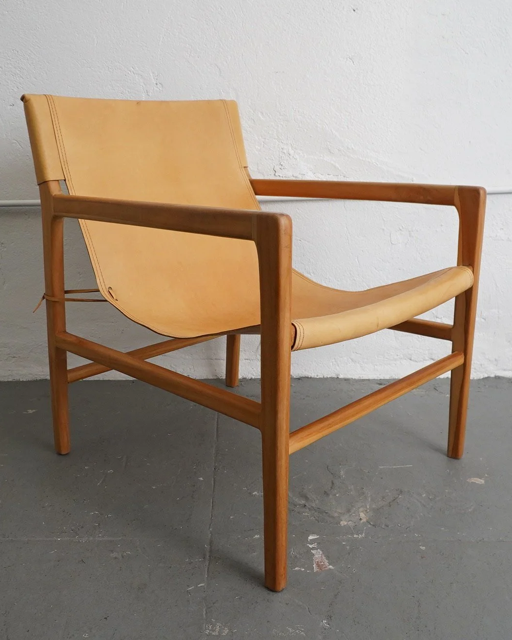 Warm Leather Sling Chair, $150, H32" x W27" x D27", 2 Available 