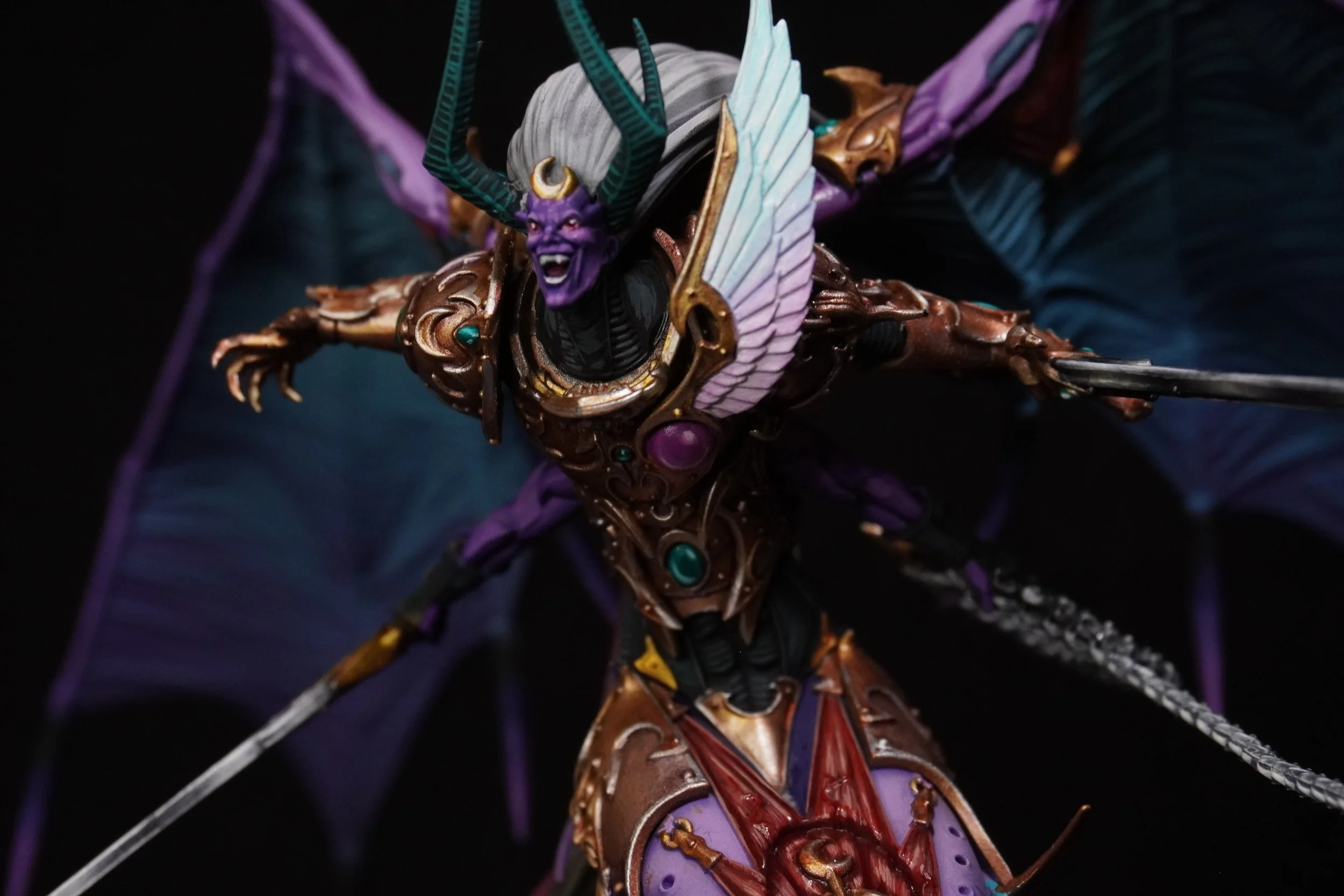 Detailed fantasy figurine of a winged demon with purple skin, horns, and an ornate armor with gemstones, holding a sword.