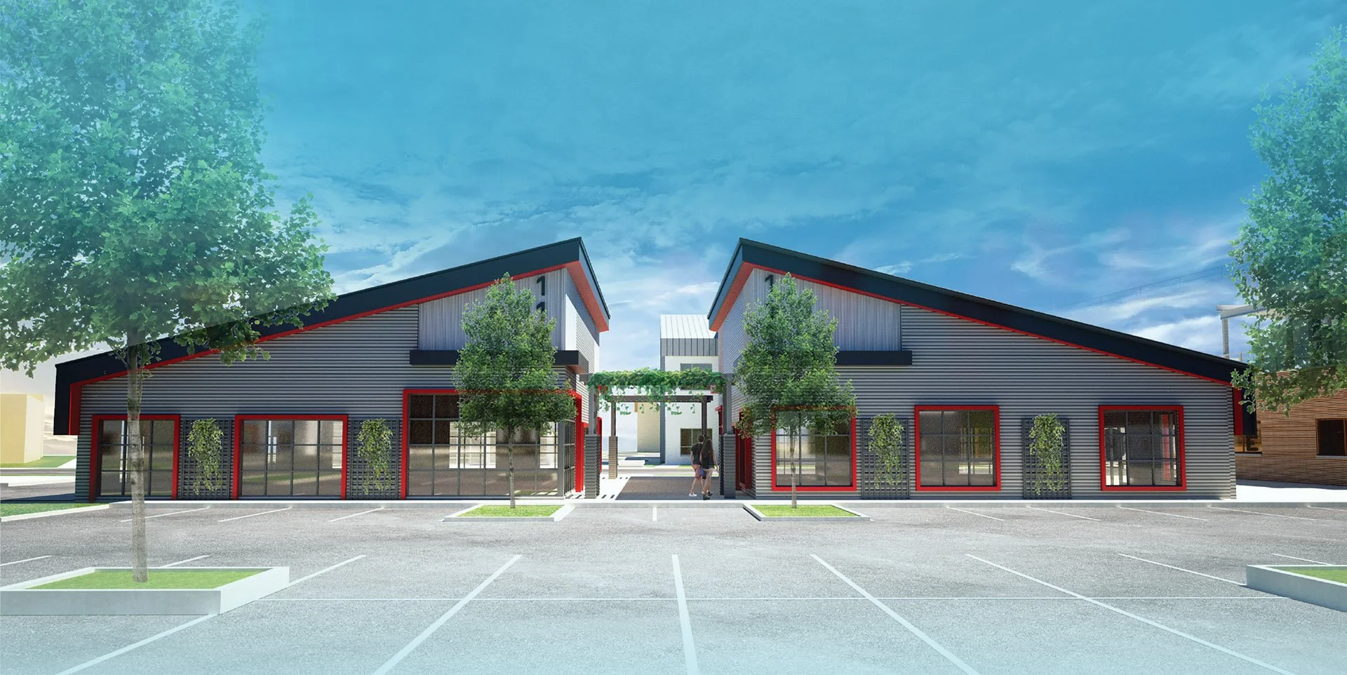 Modern commercial building with sloped roof, large windows, and landscaping. Parking lot in foreground with a few trees and parking spaces. Clear blue sky overhead.