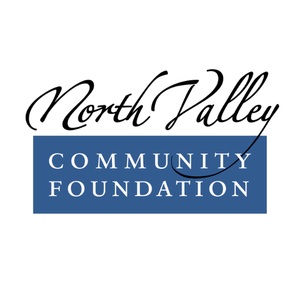 Logo of North Valley Community Foundation with black cursive text and a blue rectangular background containing white uppercase letters.