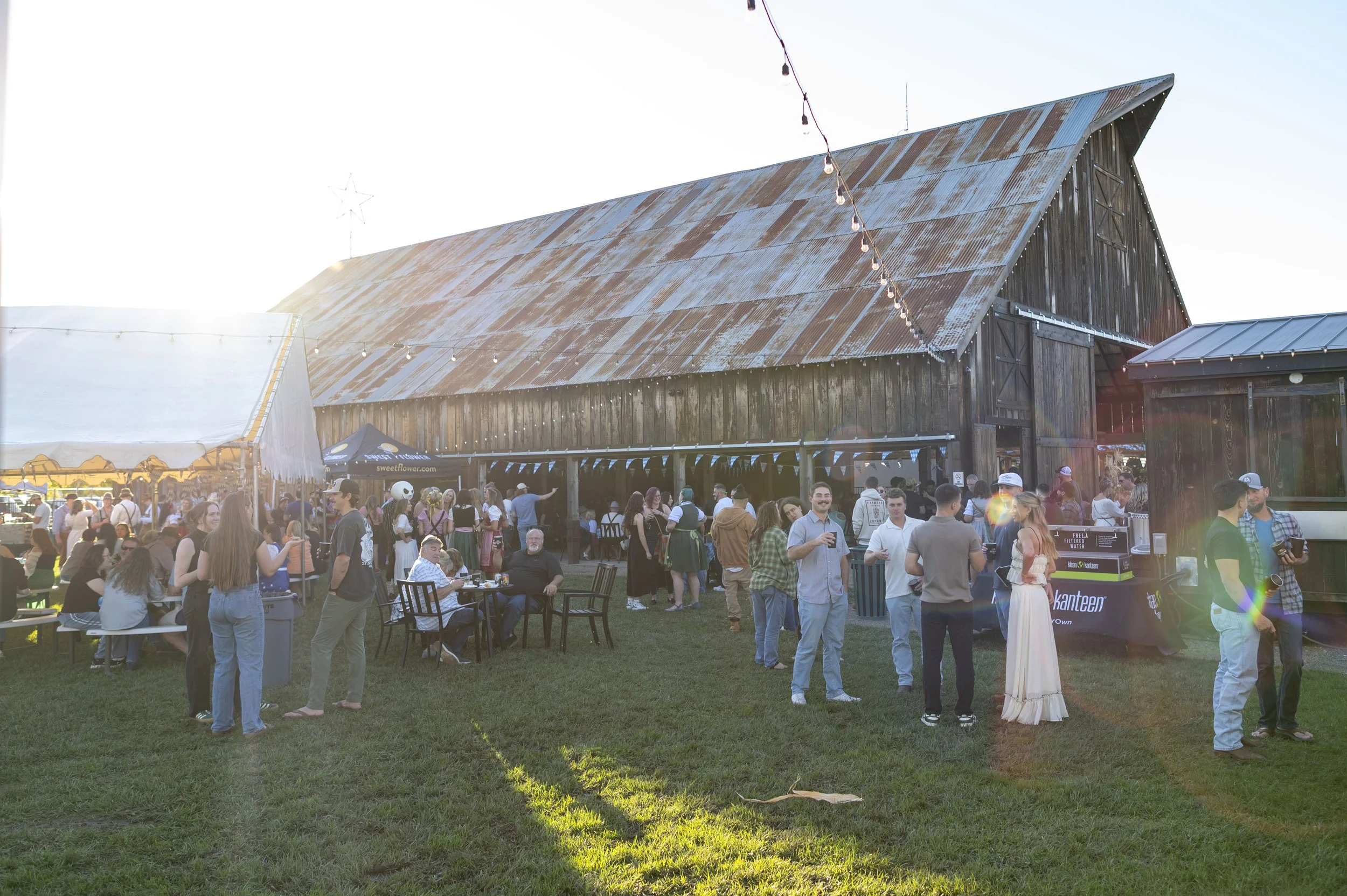 Crowd on the grass at The Barn at Meriam Park during an Oktoberfest event celebration