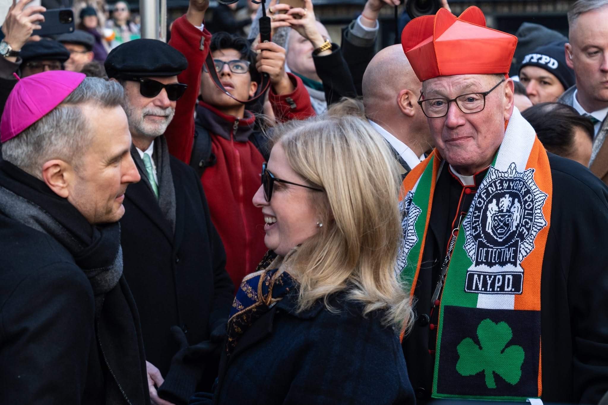 Cardinal Timothy Dolan stands behind of Archbishop Ronald Hicks and Police Commissioner