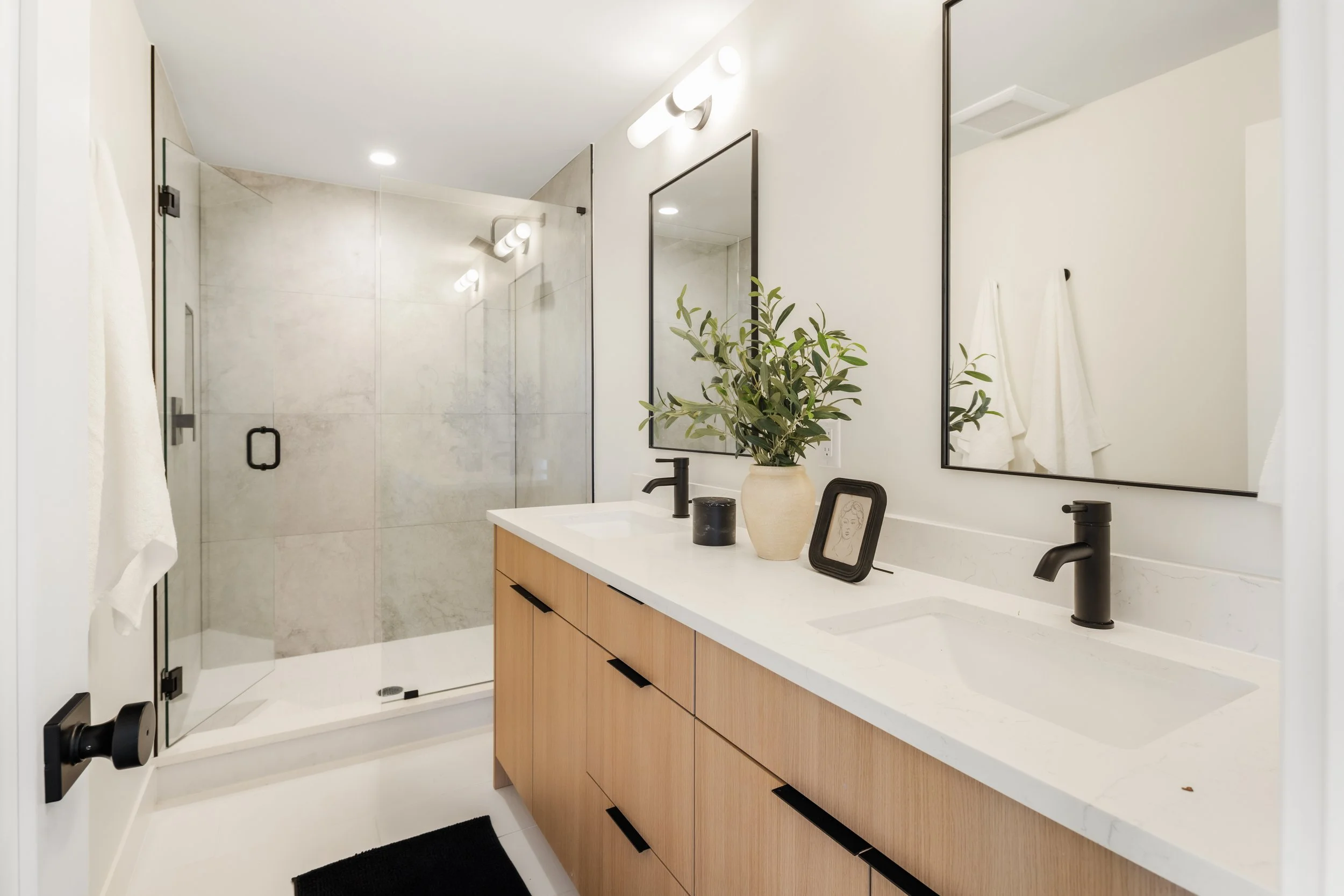 Bathroom in 2-bedroom unit at Berkeley Residences featuring contemporary vanity, tile work, and modern finishes
