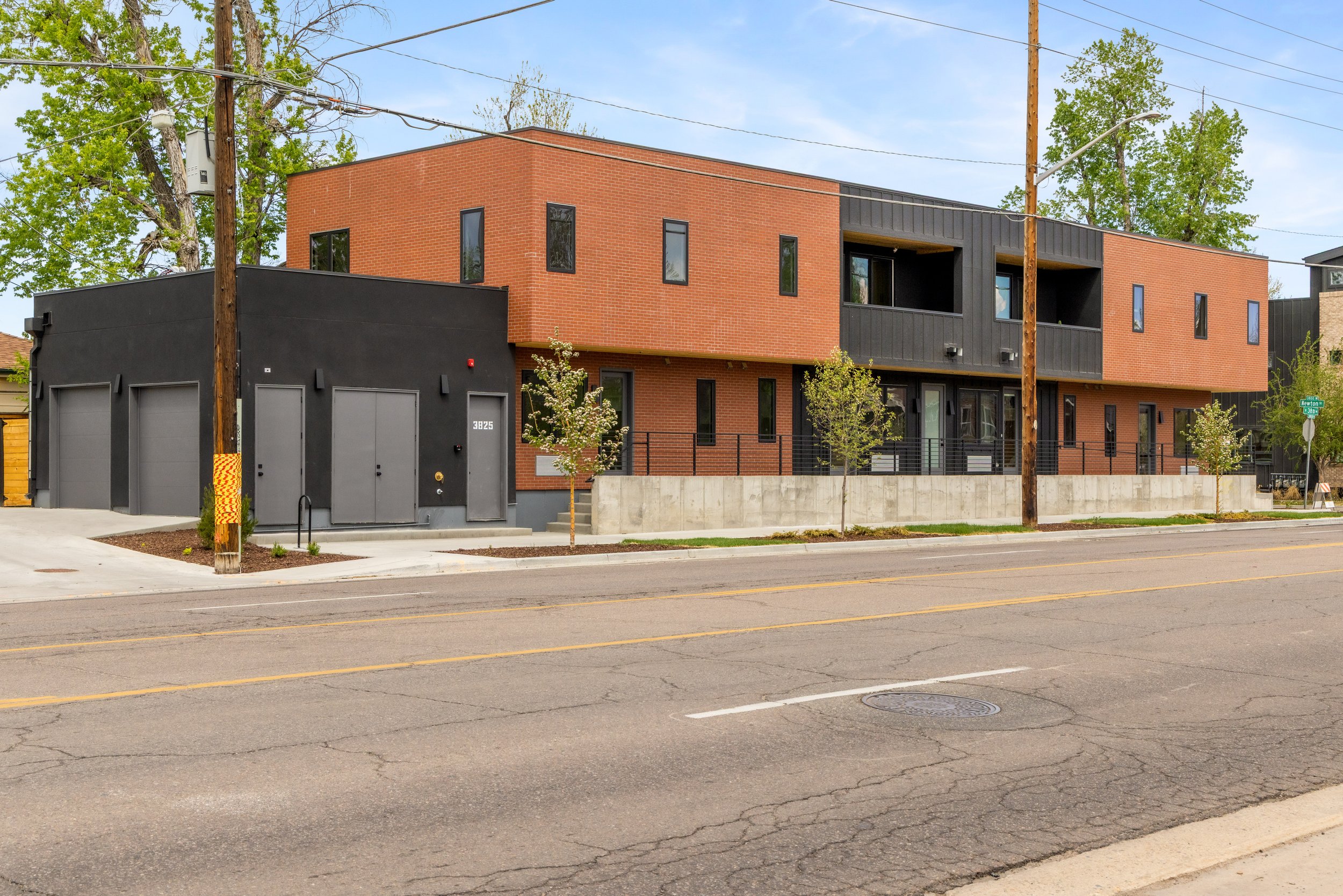 Side elevation of Berkeley Residences Denver luxury condos showing modern mixed-material facade on W 38th in the Highlands neighborhood