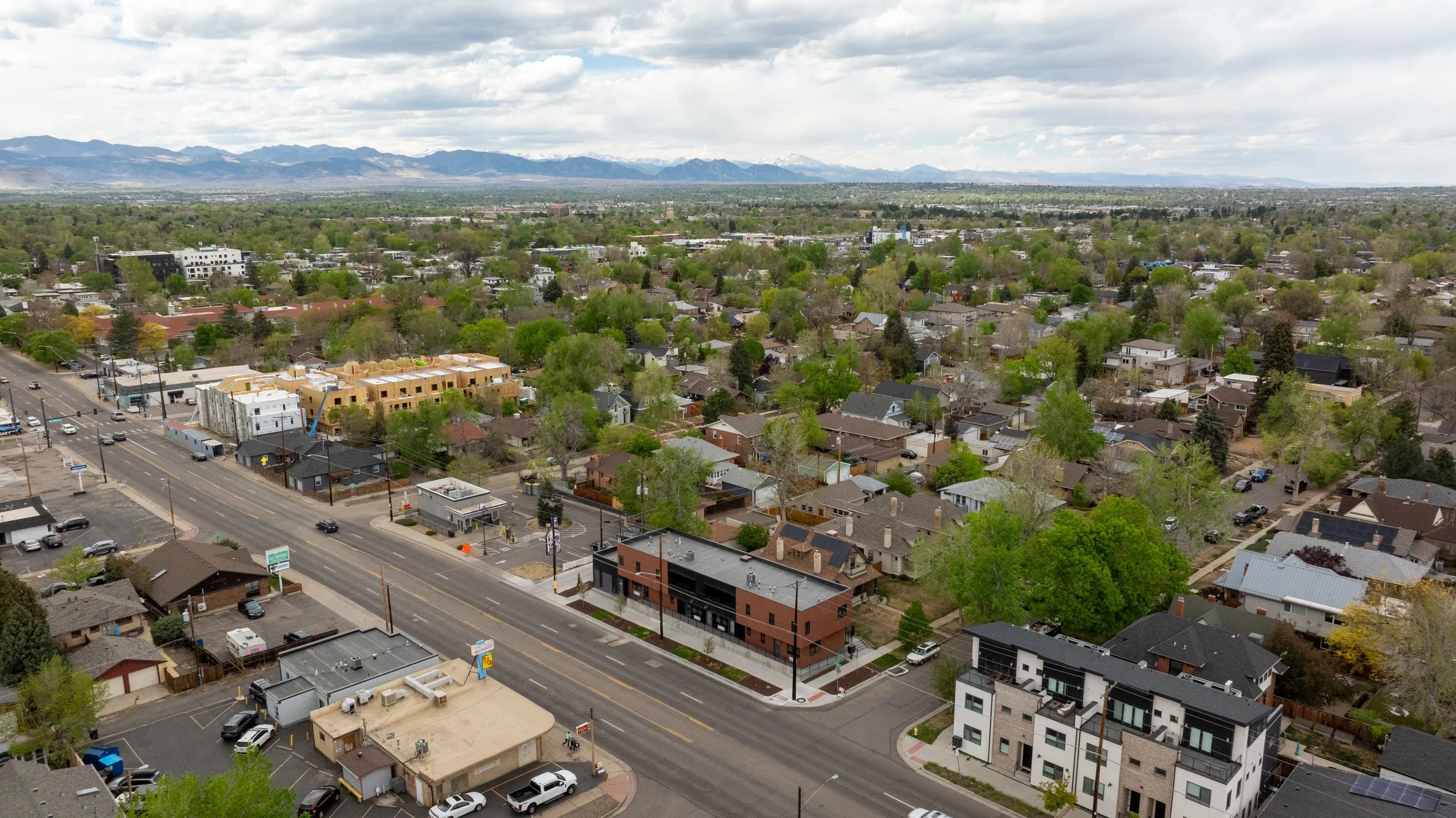 Overhead drone shot of Berkeley Residences modern condos in Denver's Highlands with surrounding neighborhood and parking visible