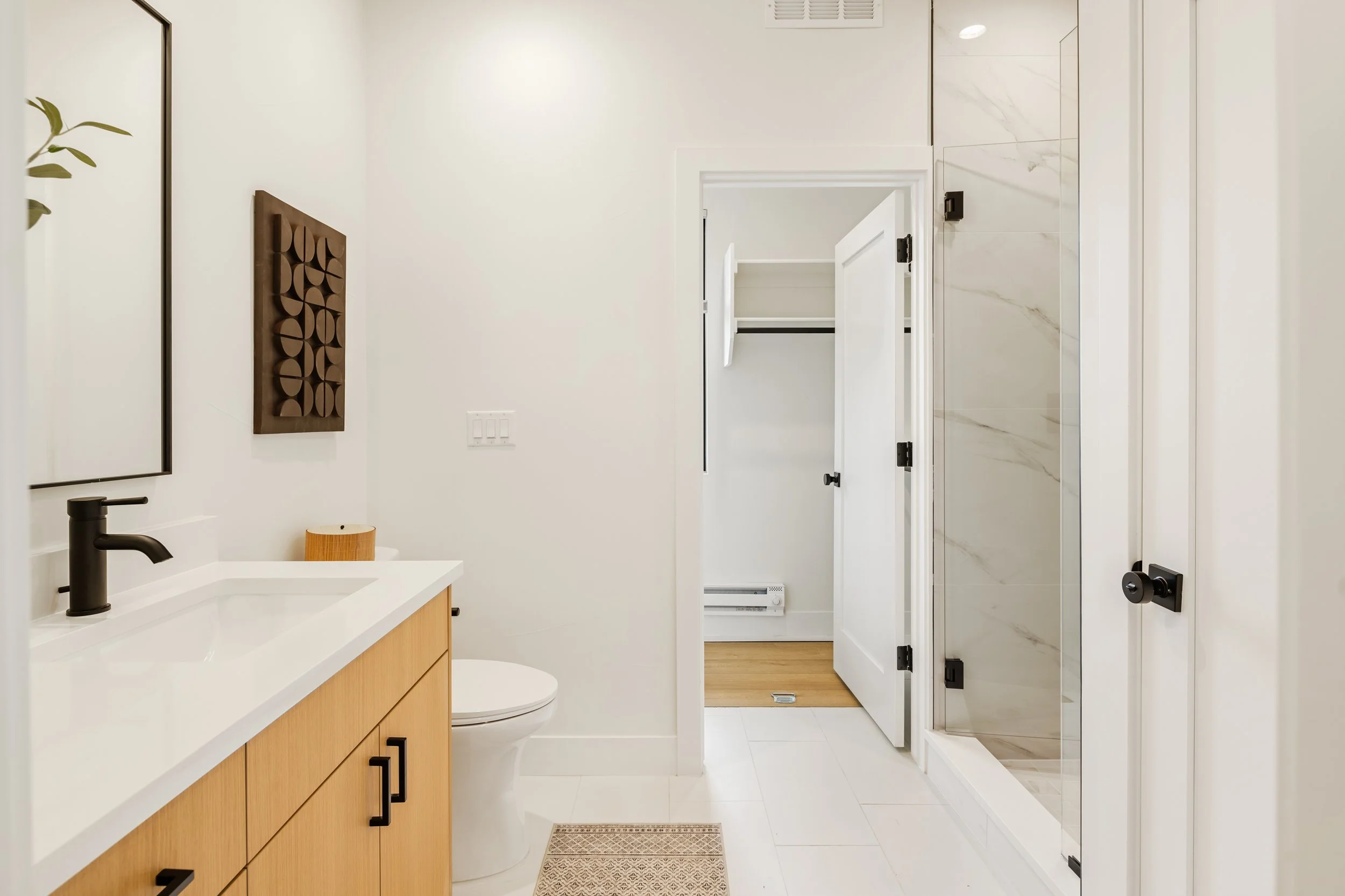Bathroom in 1-bed unit at Berkeley Residences featuring modern vanity, tiling, and contemporary fixtures in Denver luxury condo