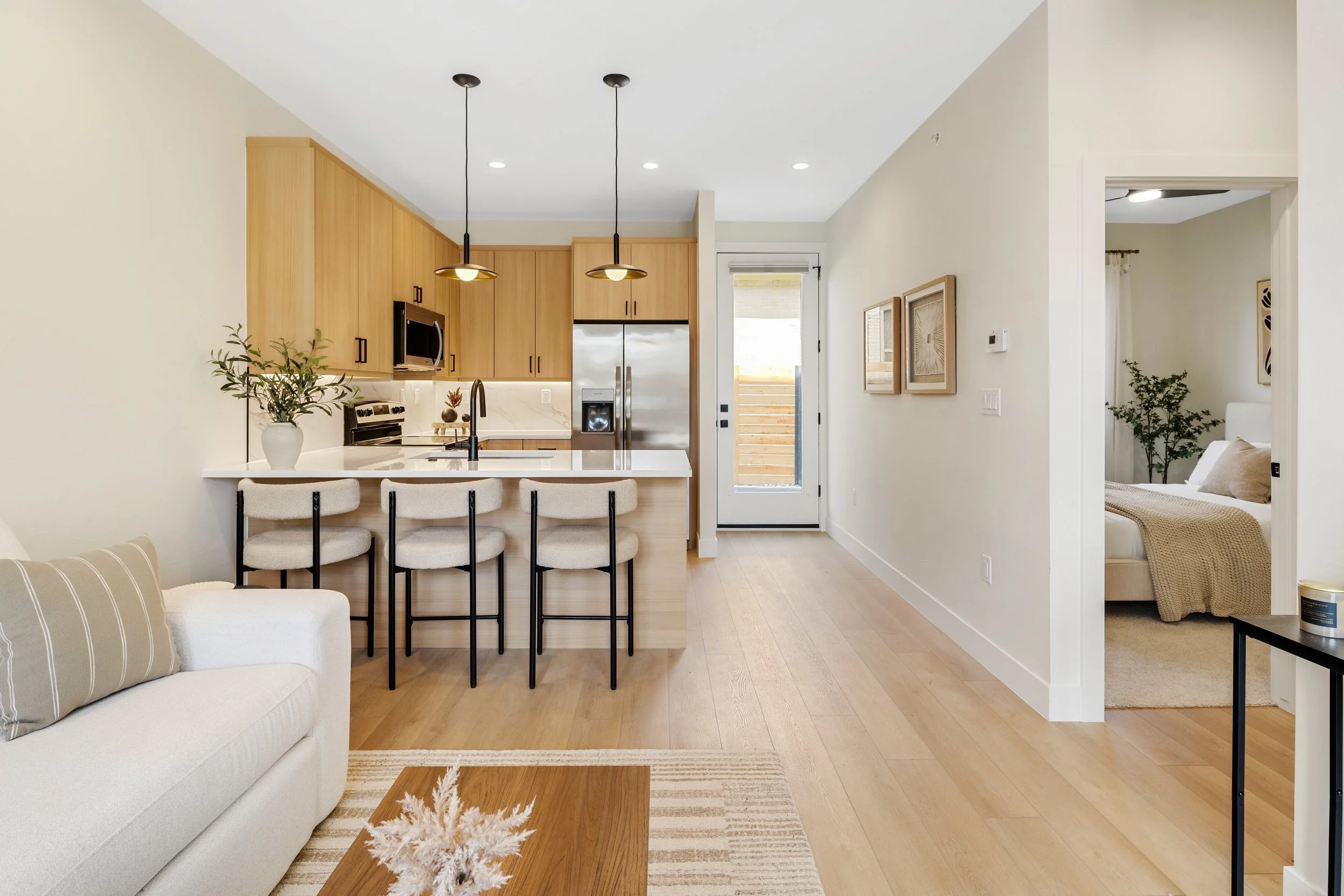 Living area in 528 SF 1-bedroom home at Berkeley Residences Denver showing open layout and abundant natural light