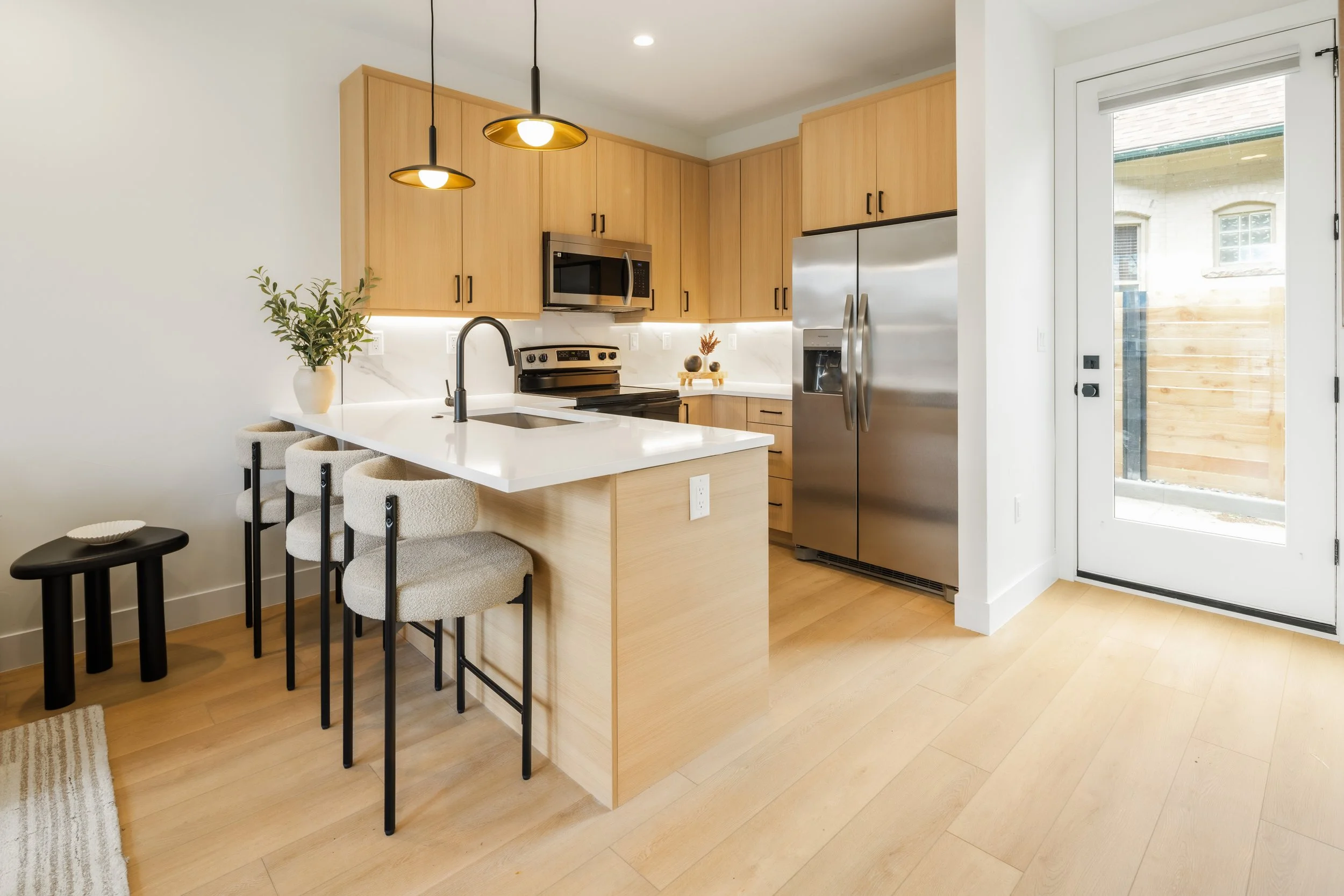 Details of contemporary kitchen in 1-bed Denver condo at Berkeley Residences with modern cabinetry and finishes