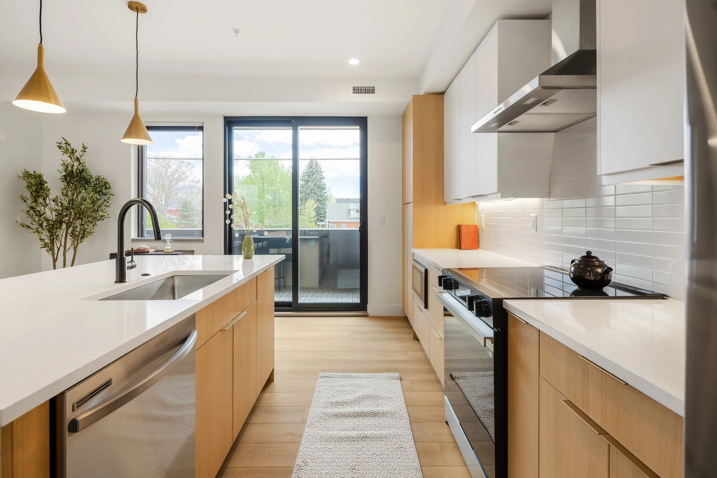 Kitchen details in 2-bed home at Berkeley Residences showing white cabinetry, modern hardware, and Denver luxury finishes