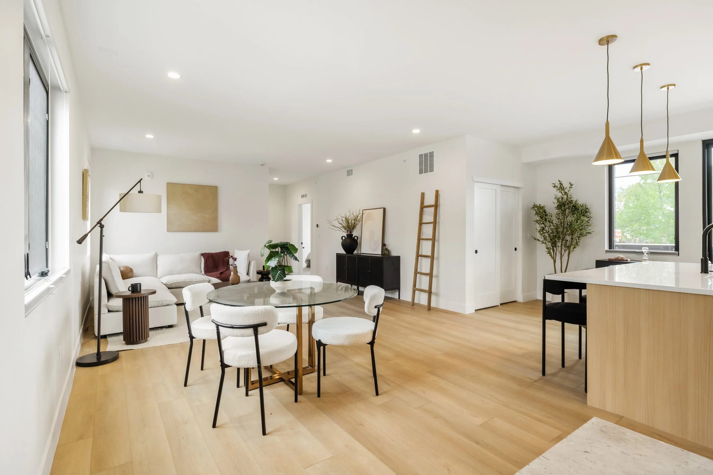 Open concept living room in 2-bedroom luxury condo at Berkeley Residences Denver, contemporary design with large windows