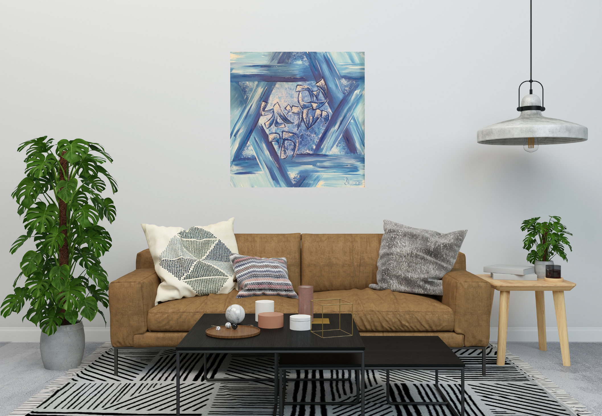 Living room with a beige sofa, decorative pillows, a black coffee table with various objects, a striped rug, a large green potted plant, a side table with a smaller plant, books, and a dark-colored candle holder, a blue abstract art painting on the white wall, and a hanging gray industrial pendant light.