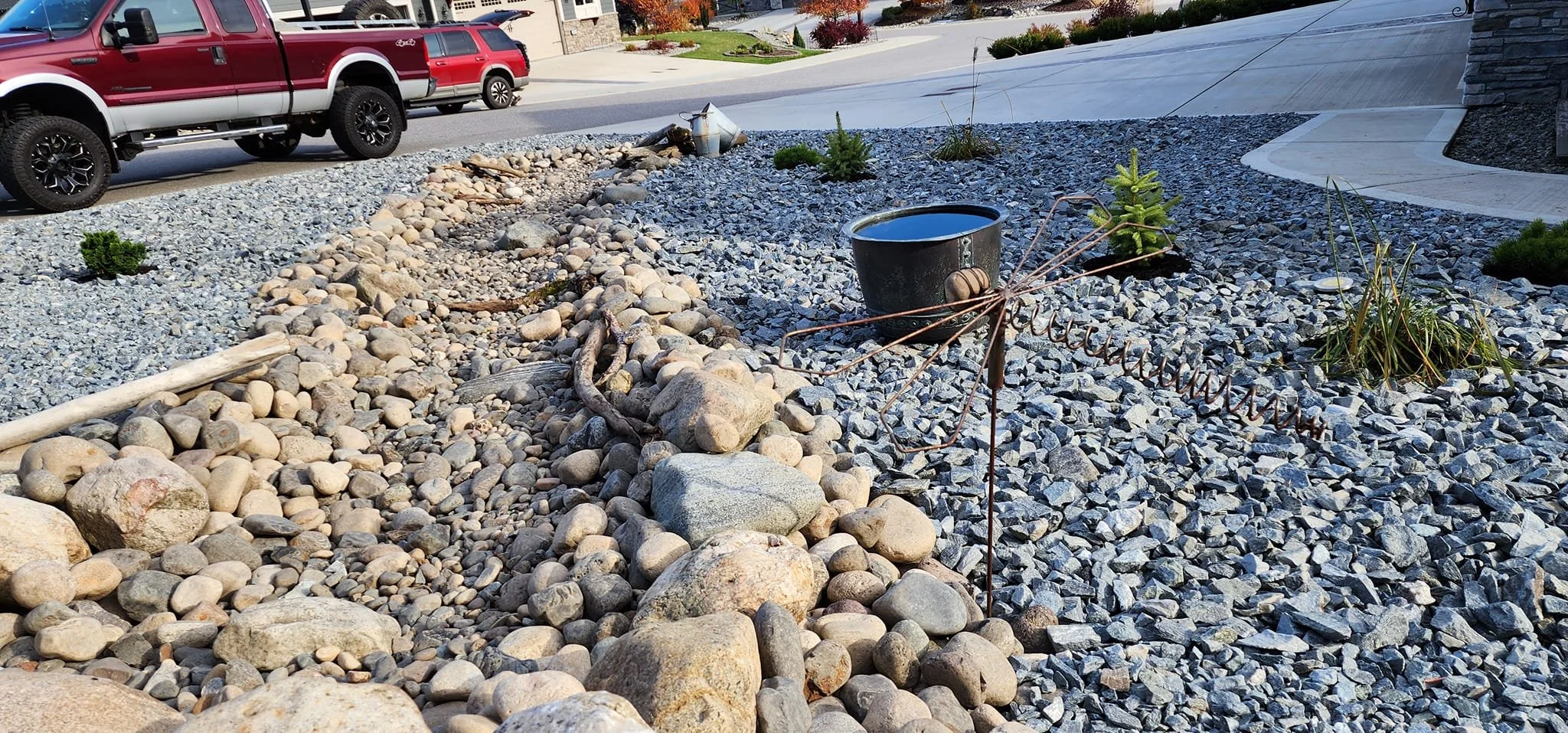 Decorative rock landscaping and dry creek bed installation in Armstrong BC.
