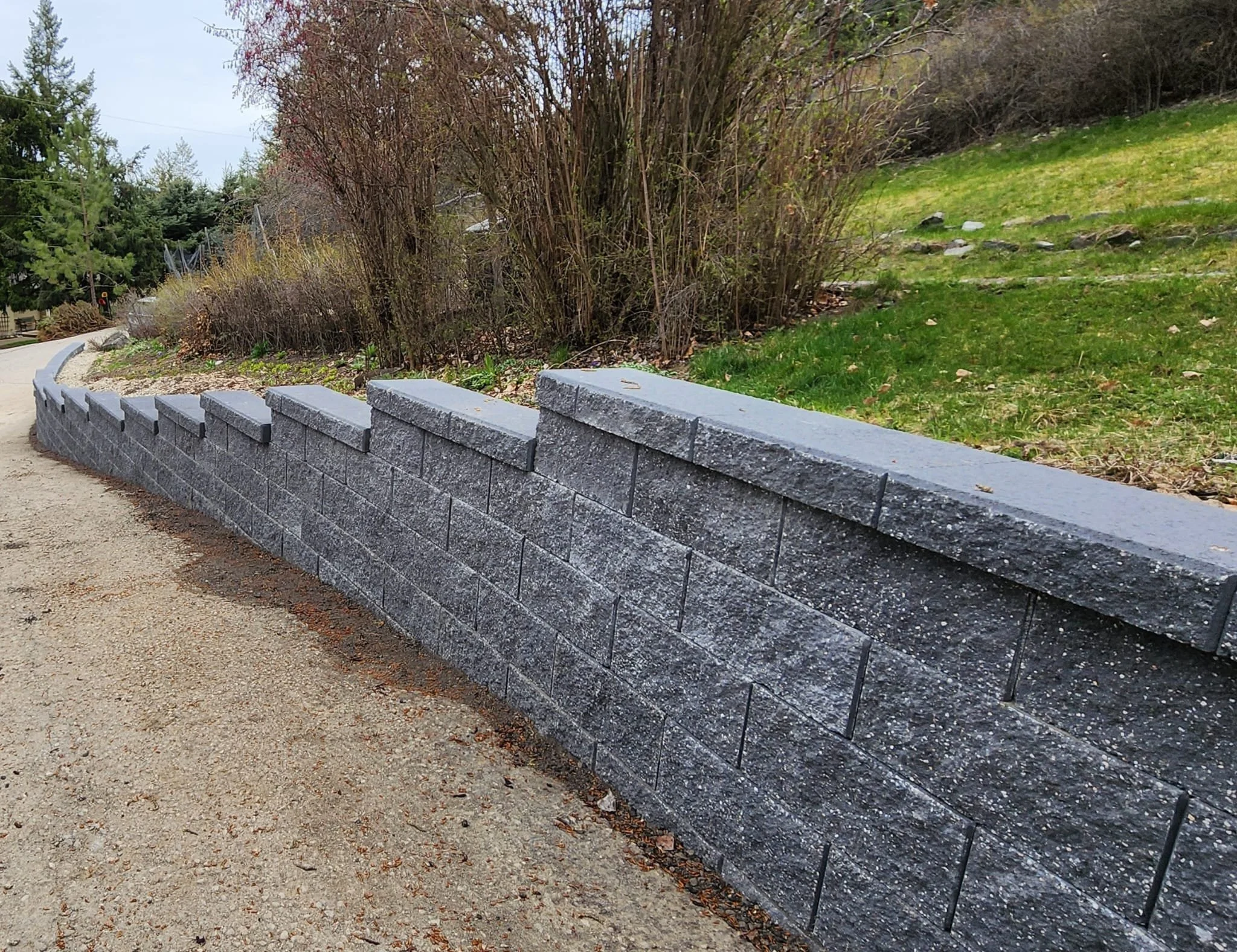 Custom retaining wall construction enhancing usable outdoor space and landscape design.