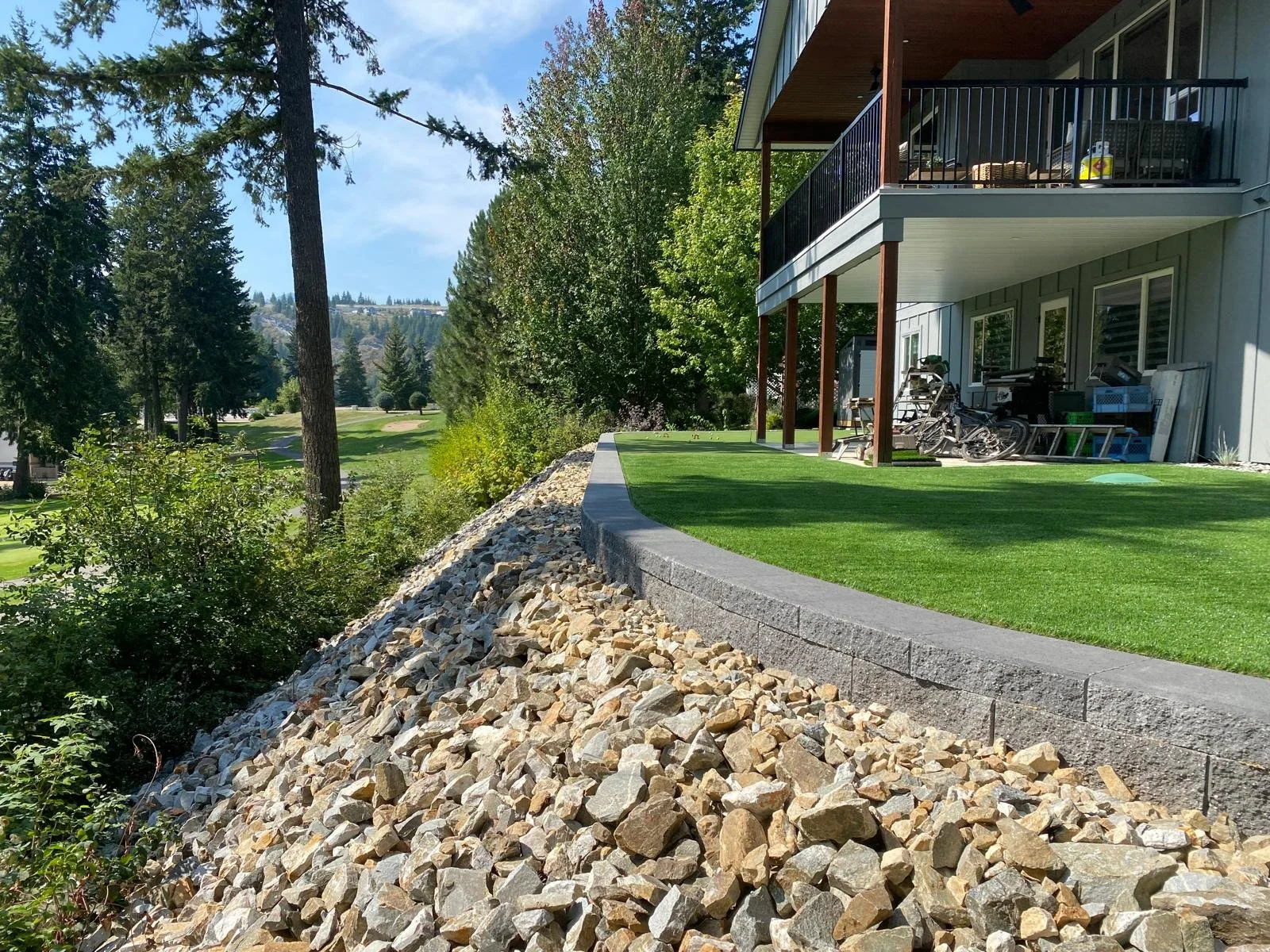 New retaining wall construction integrated with a patio and outdoor living space.