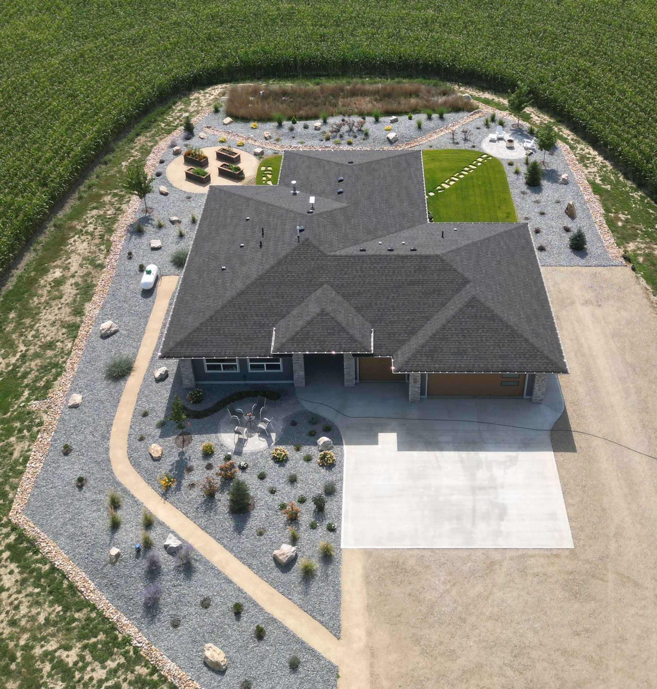 Complete landscape construction project in Armstrong BC featuring planting beds, decorative rock, and lawn areas.